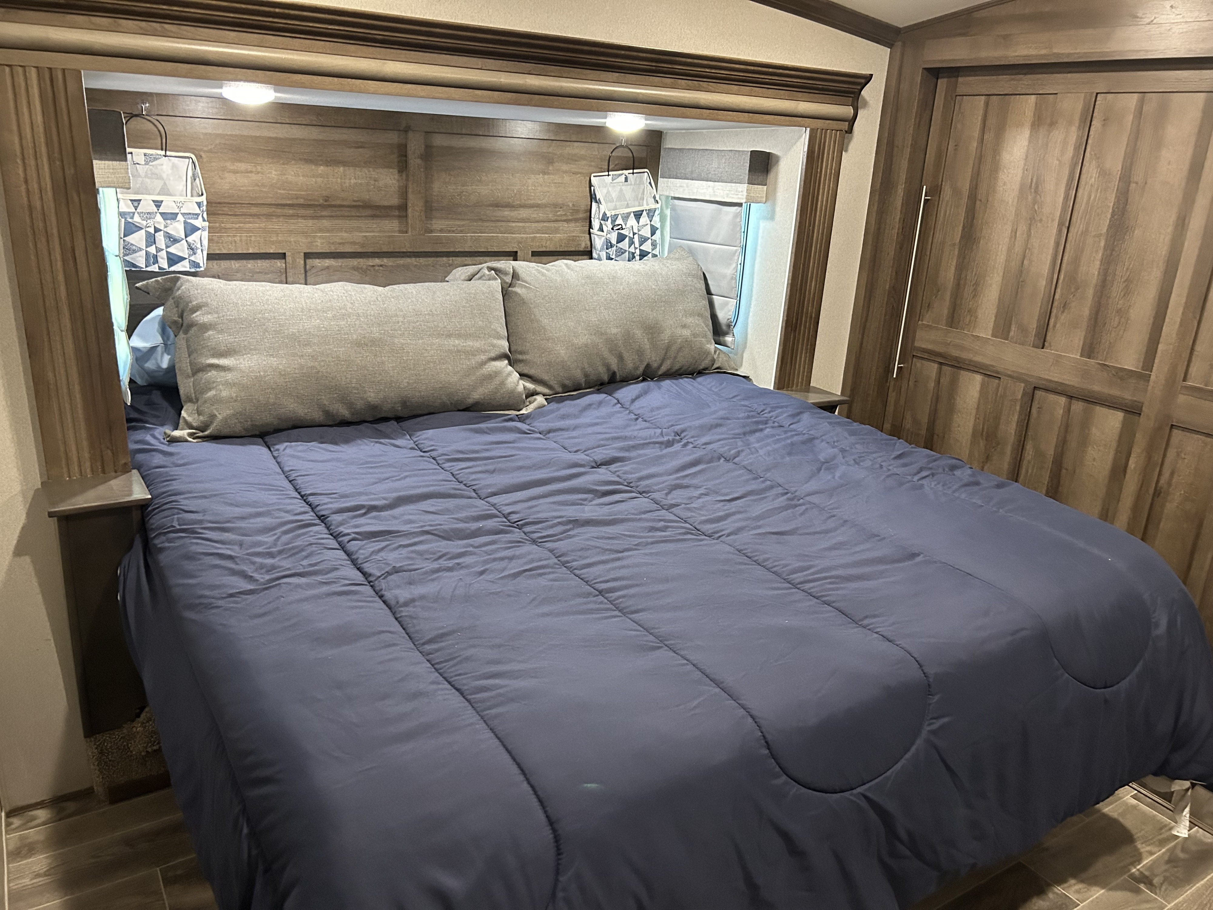 Master bedroom with king-size bed. 2 large sliding door closets and large cabinet. . Forest River Cardinal Limited 2019