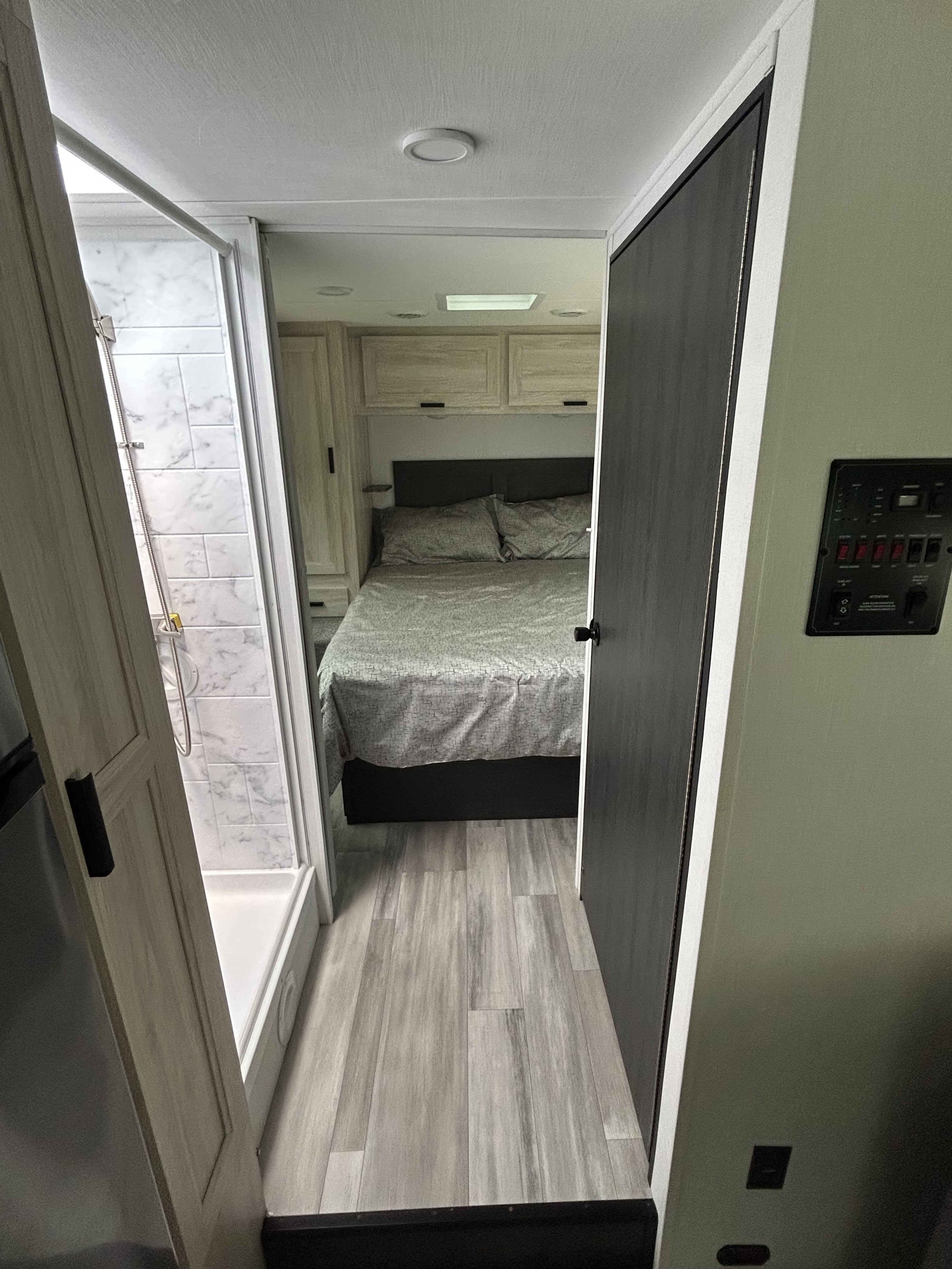 View inside an RV rental showing a modern bedroom, full shower, and comfortable living space. Ready for your next journey!. Forest River Other 2023