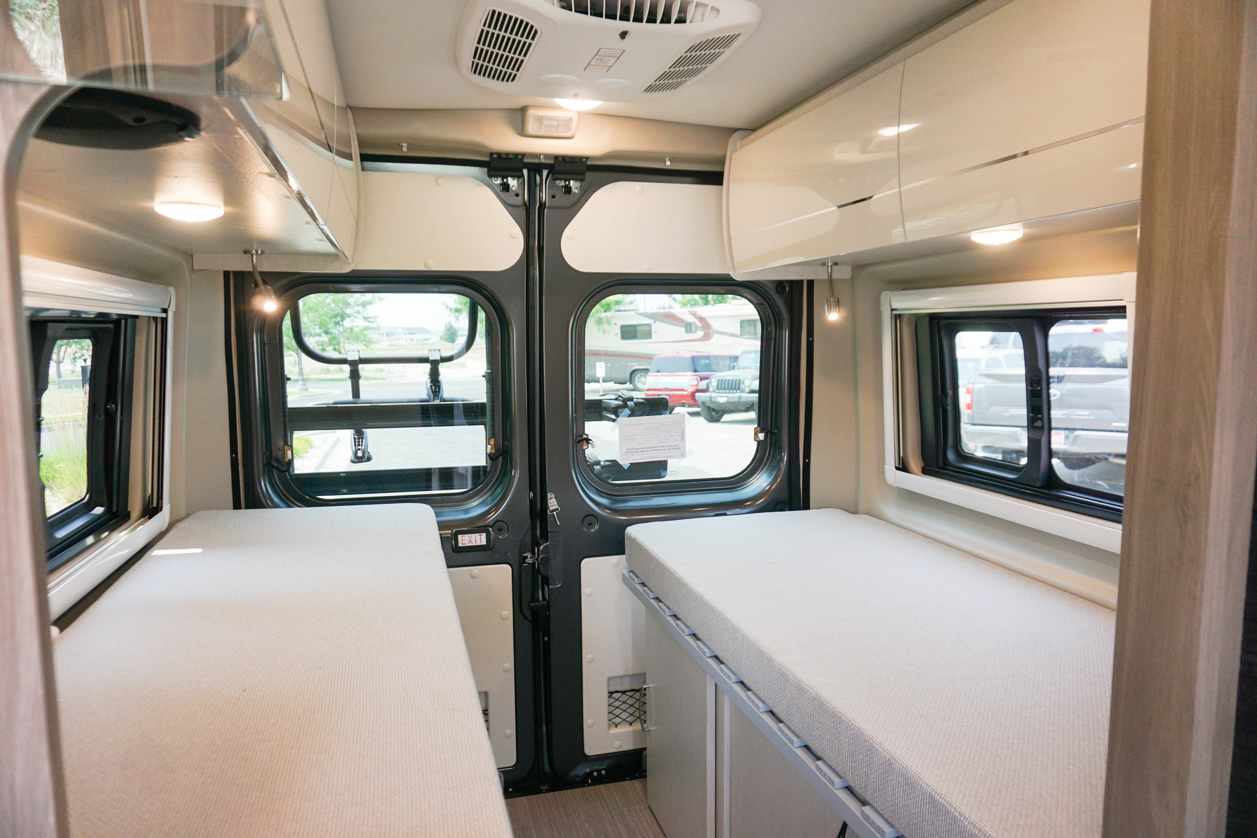 Experience comfort in this RV rental's versatile interior, featuring twin beds, bright windows, and ample storage.. Thor Tellaro 2022