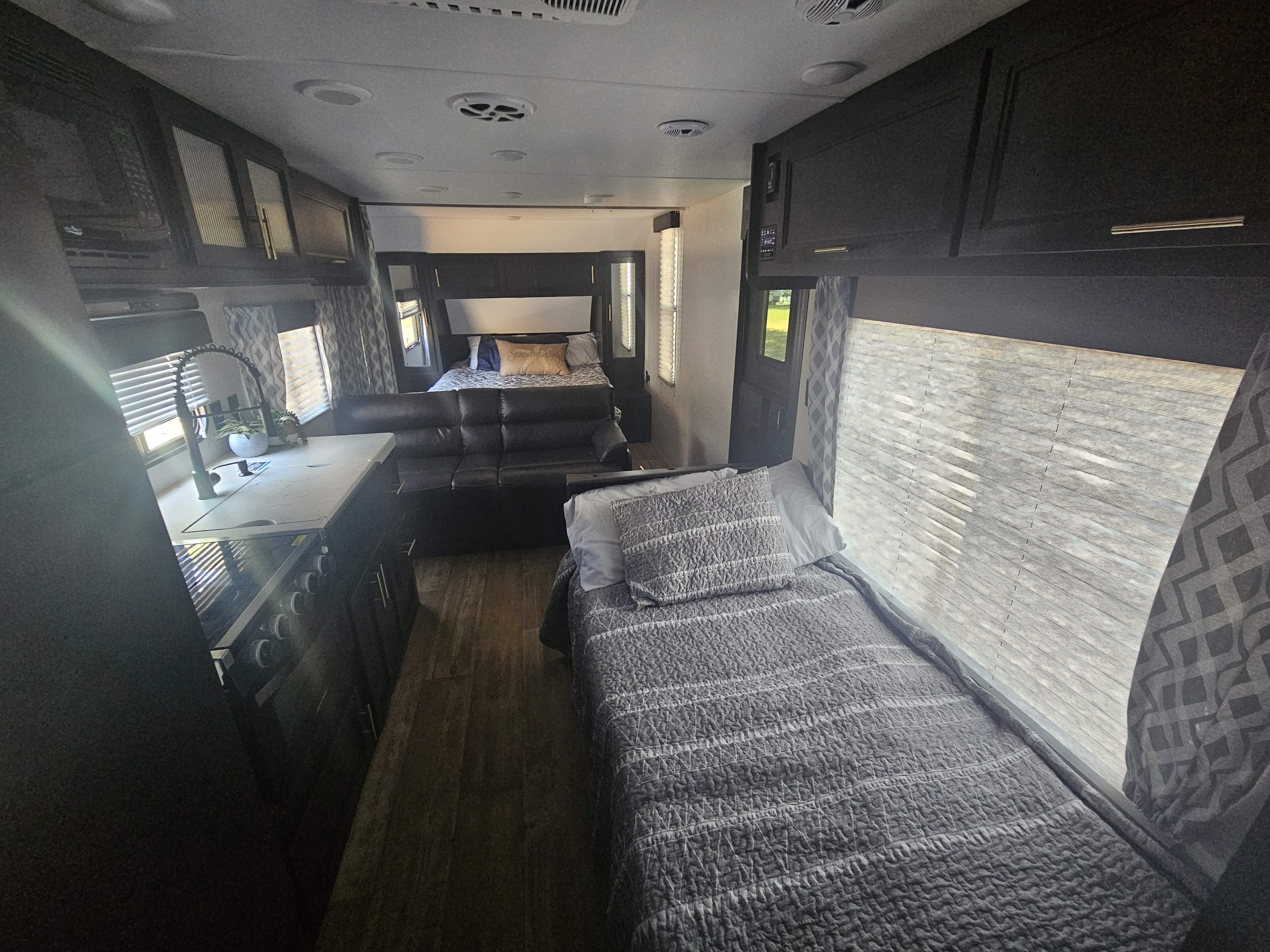 Spacious RV rental interior with kitchen, sofa, and comfortable sleeping areas, ready for travel.. Forest River Cherokee Grey Wolf Special Edition 2022