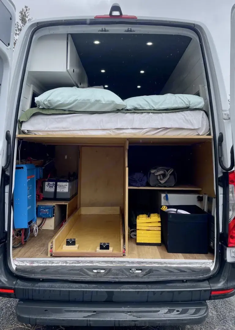 Inside a spacious camper van RV rental. Features include a comfy bed, efficient electrical system, and smart storage.. Mercedes Sprinter 2020