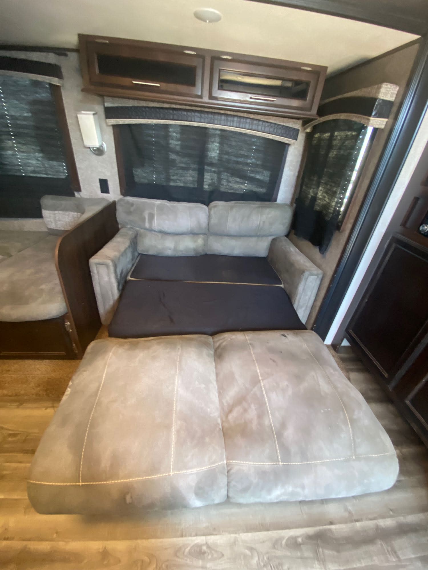 RV rental interior with a comfortable pull-out sofa bed, cabinets, and windows. Ideal for your next camper trip.. Jayco Jay Flight 2018