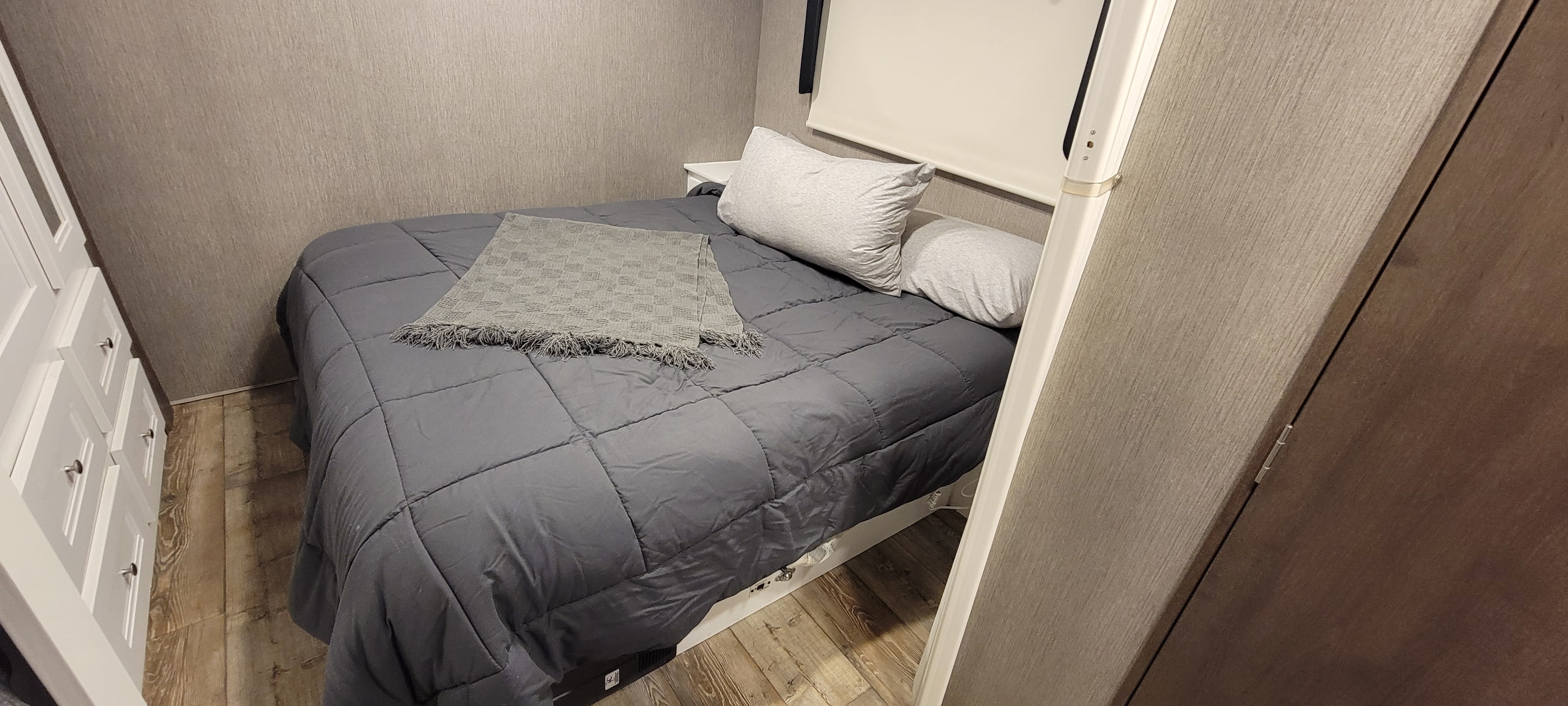 Queen bed with privacy door. Storage behind and under the tv. 6 drawers and two closets. Night stands and outlets on each side. Nexus RV Phantom 2023