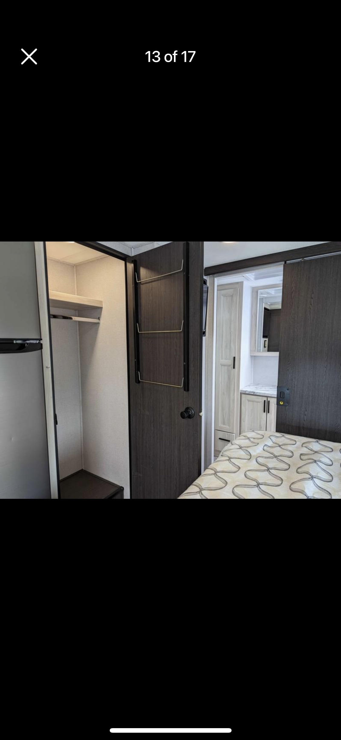 Compact RV rental: Bedroom area with built-in fridge, closet, and sliding door to a modern bathroom vanity.. Forest River Sunseeker Classic 2021