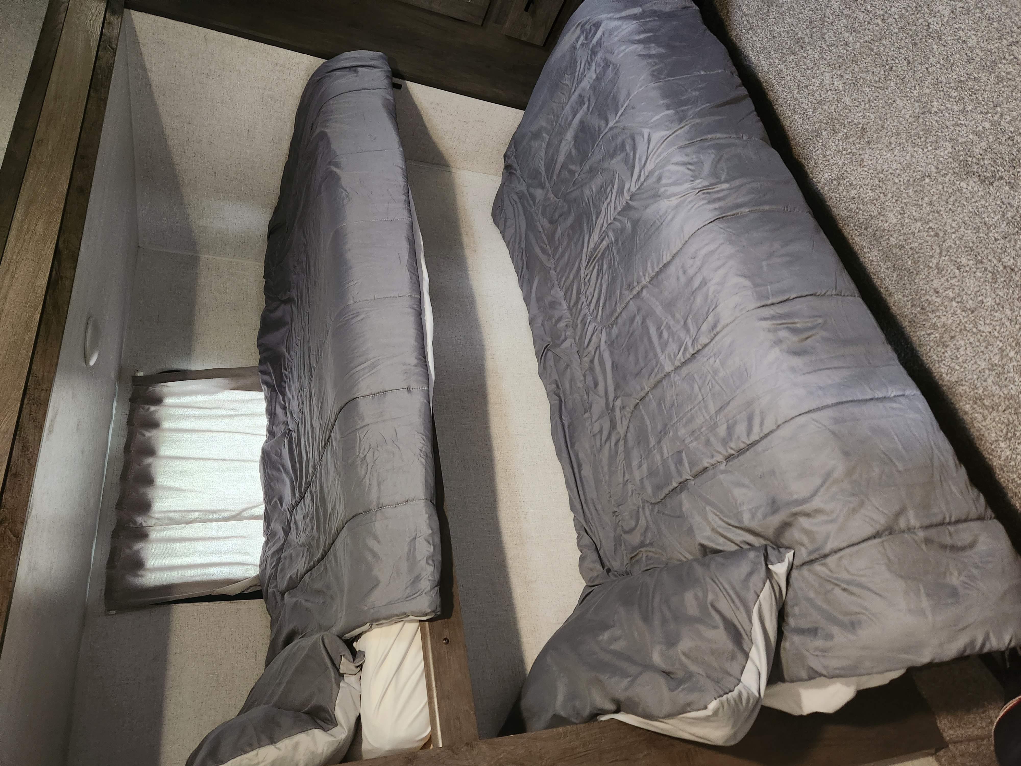 Cozy gray bunk beds in an RV rental, ready for comfortable sleeping during your travels.. Forest River Salem 2021
