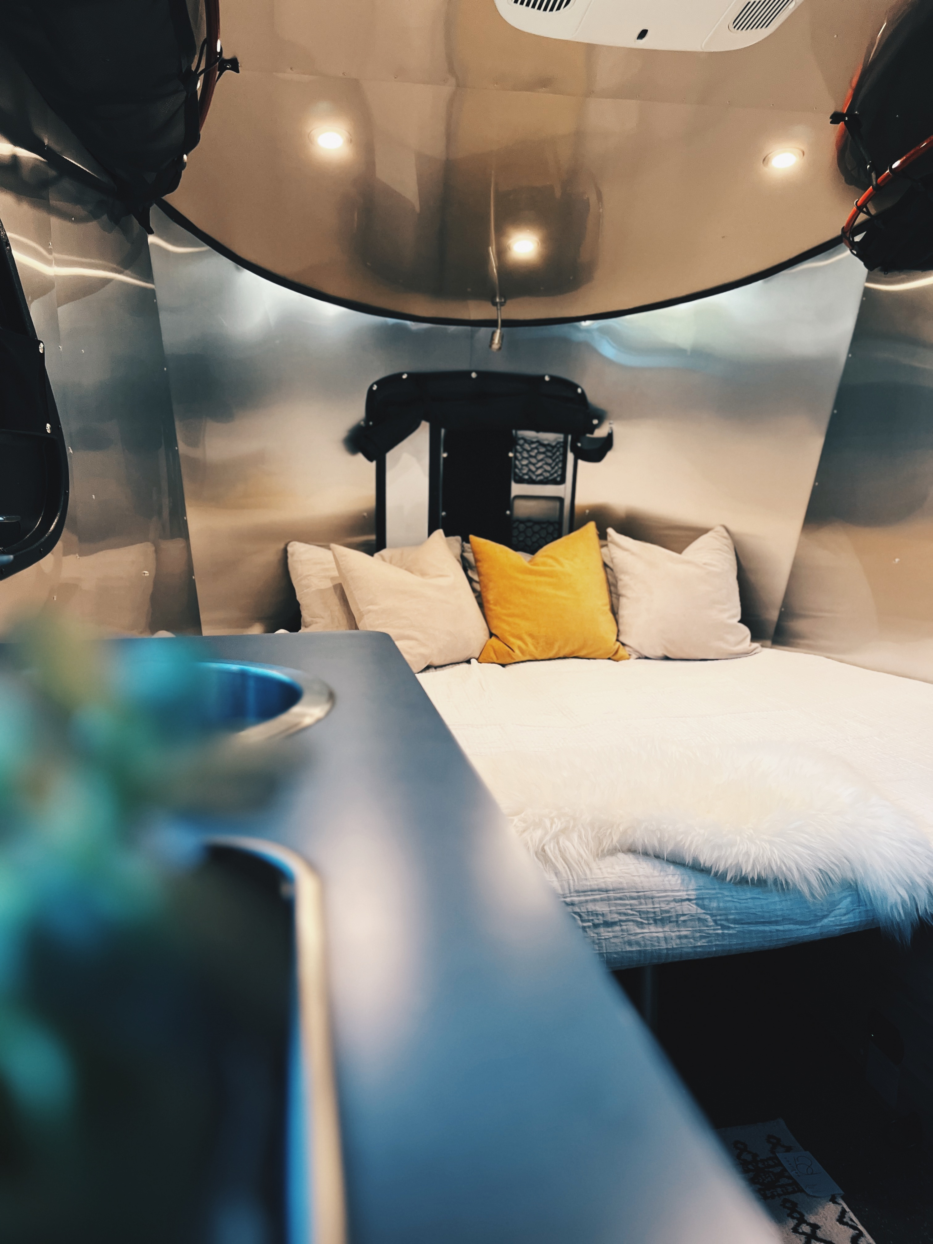 A nearly king sized bed can comfortably fit two adults (and an additional smaller human.) Sheets & comforter included. BYOP – Bring your own pillow!. Airstream Basecamp 2023
