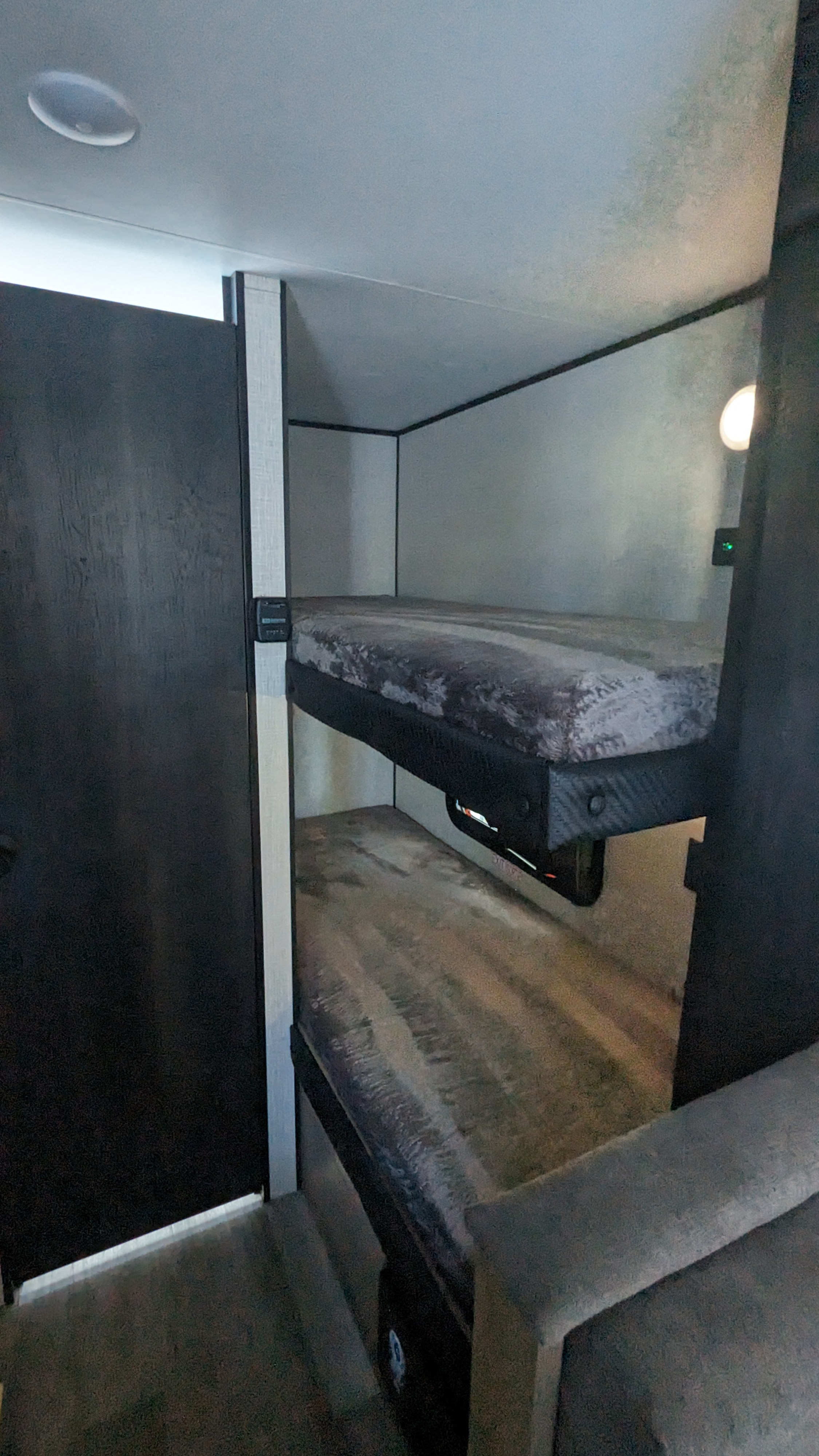 RV rental bunk beds: A cozy, compact sleeping area with upper and lower bunks, illuminated by interior lighting.. Jayco Jay Flight SLX 184BSW 2024