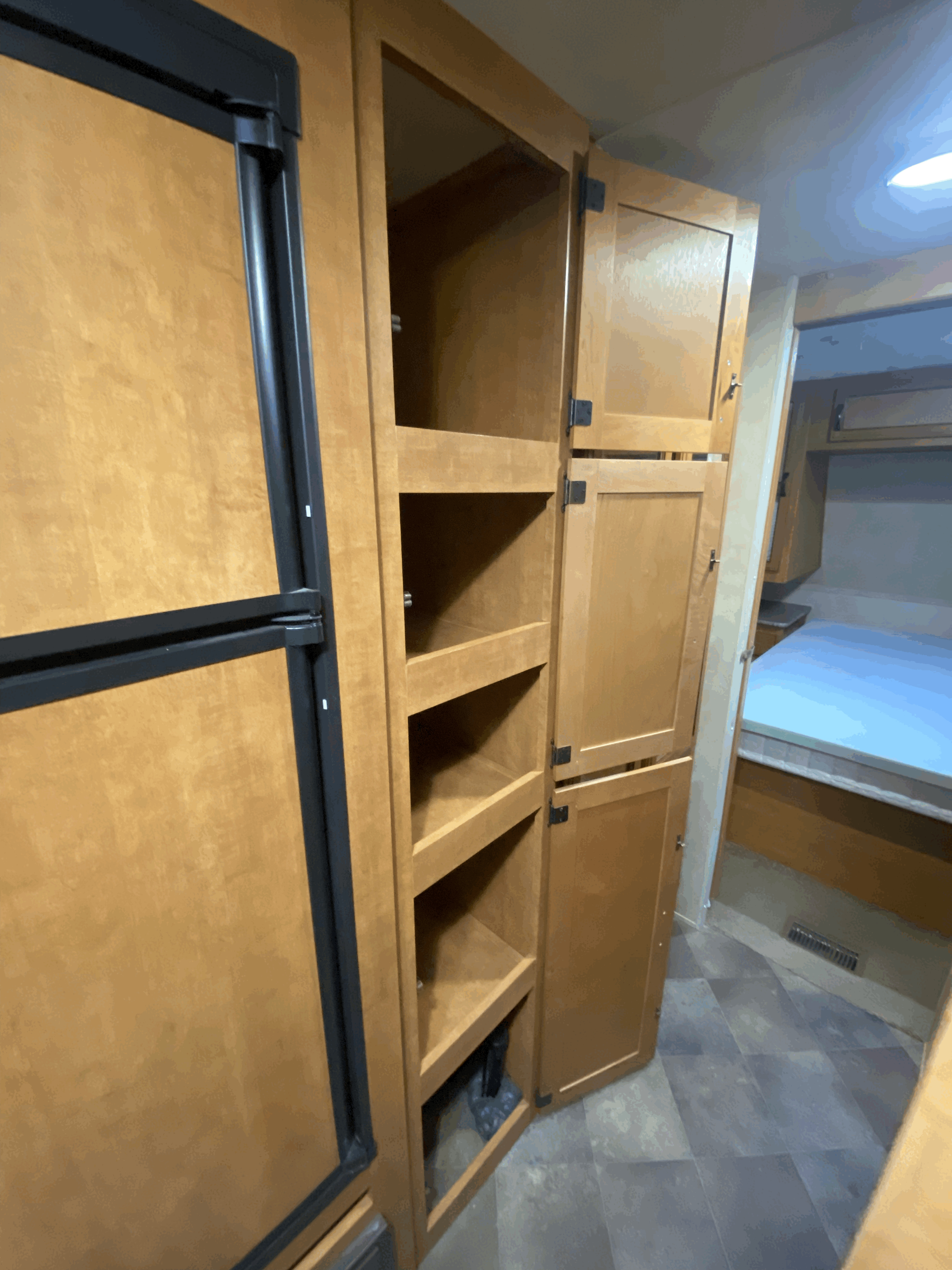 RV rental: Well-organized interior featuring a refrigerator, open shelves, and cabinets leading to the bedroom.. Forest River Palomino Puma 2014