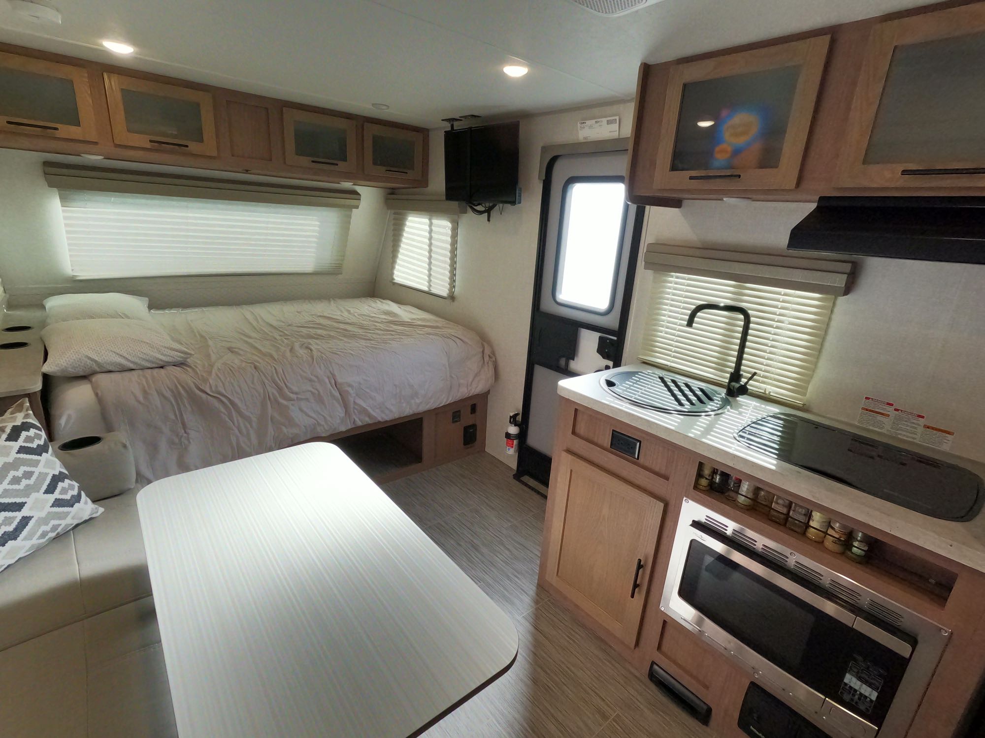 Explore this rv rental: comfy bed, full kitchen with microwave, and dining nook inside a compact camper.. No Boundaries 19.8 2021