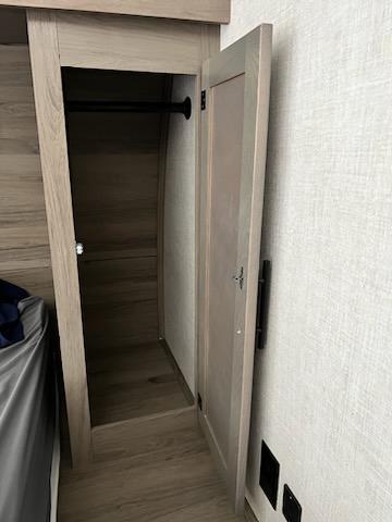 Closet storage space on either side of master bed. . Gulf Stream Ameri-Lite 2021