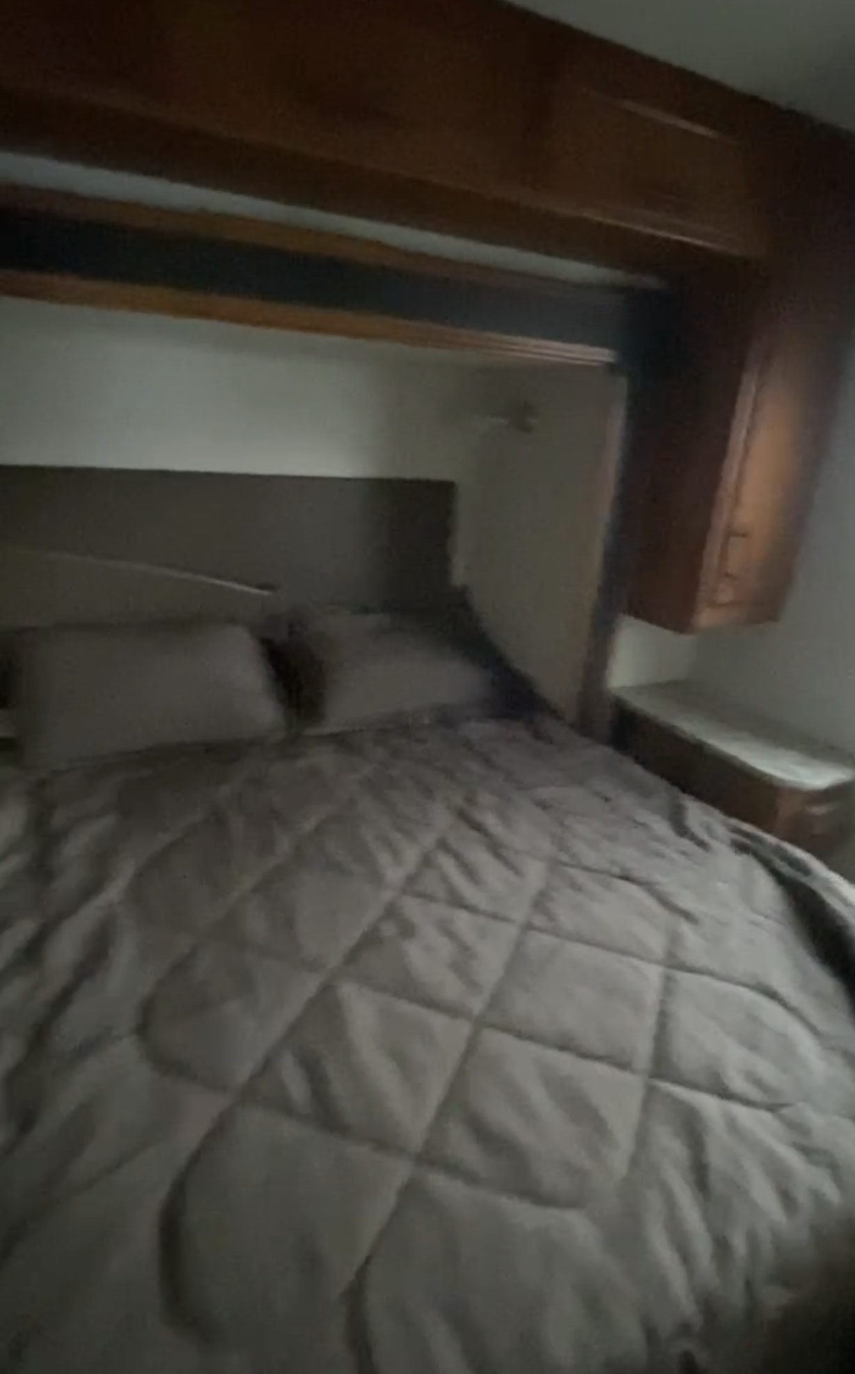 RV rental: Cozy bedroom with a comfortable bed, quilted comforter, and wooden overhead cabinets for storage.. Jayco Redhawk 2017