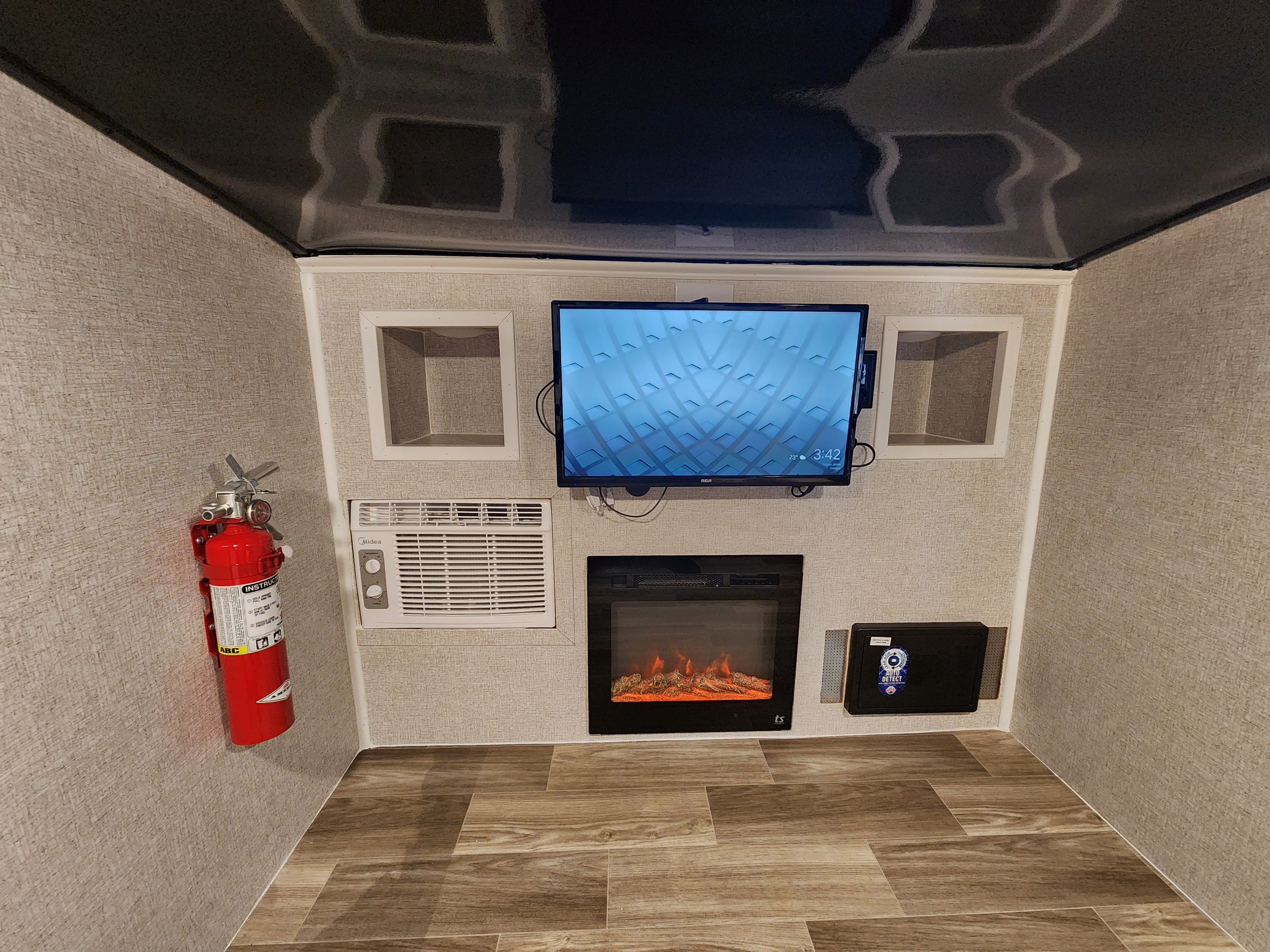 Cozy RV rental interior with TV, electric fireplace, AC, fire extinguisher, and cubbies for a comfortable stay.. Modern Buggy Little Buggy 10LR 2024