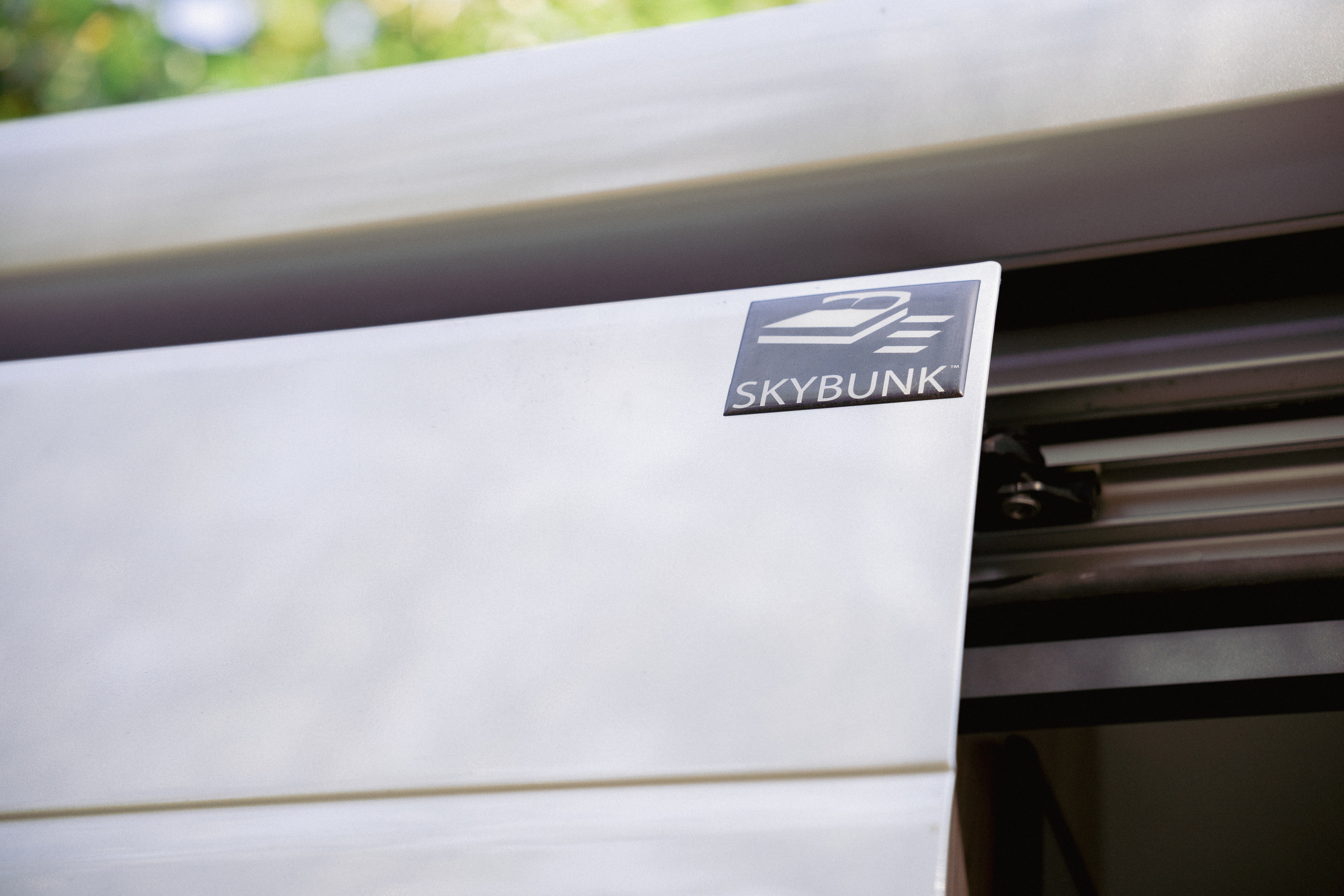 Discover comfort in your rv rental: a close-up of the "SKYBUNK" compact bunk system in a camper van.. Thor Sequnce 2023