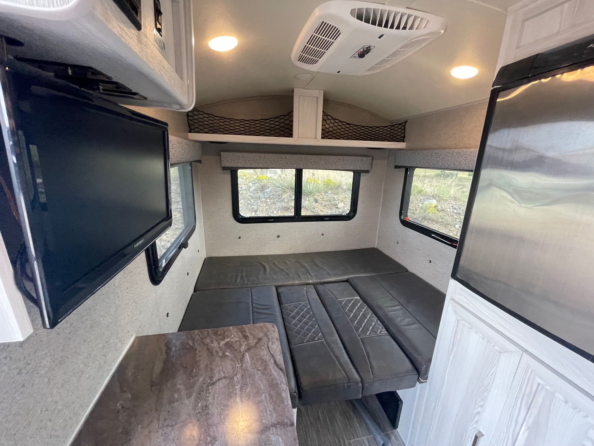 Enjoy a comfortable rv rental! This compact interior features a bed, TV, AC, and a small counter for your travels.. Forest River Rockwood Geo Pro 2018