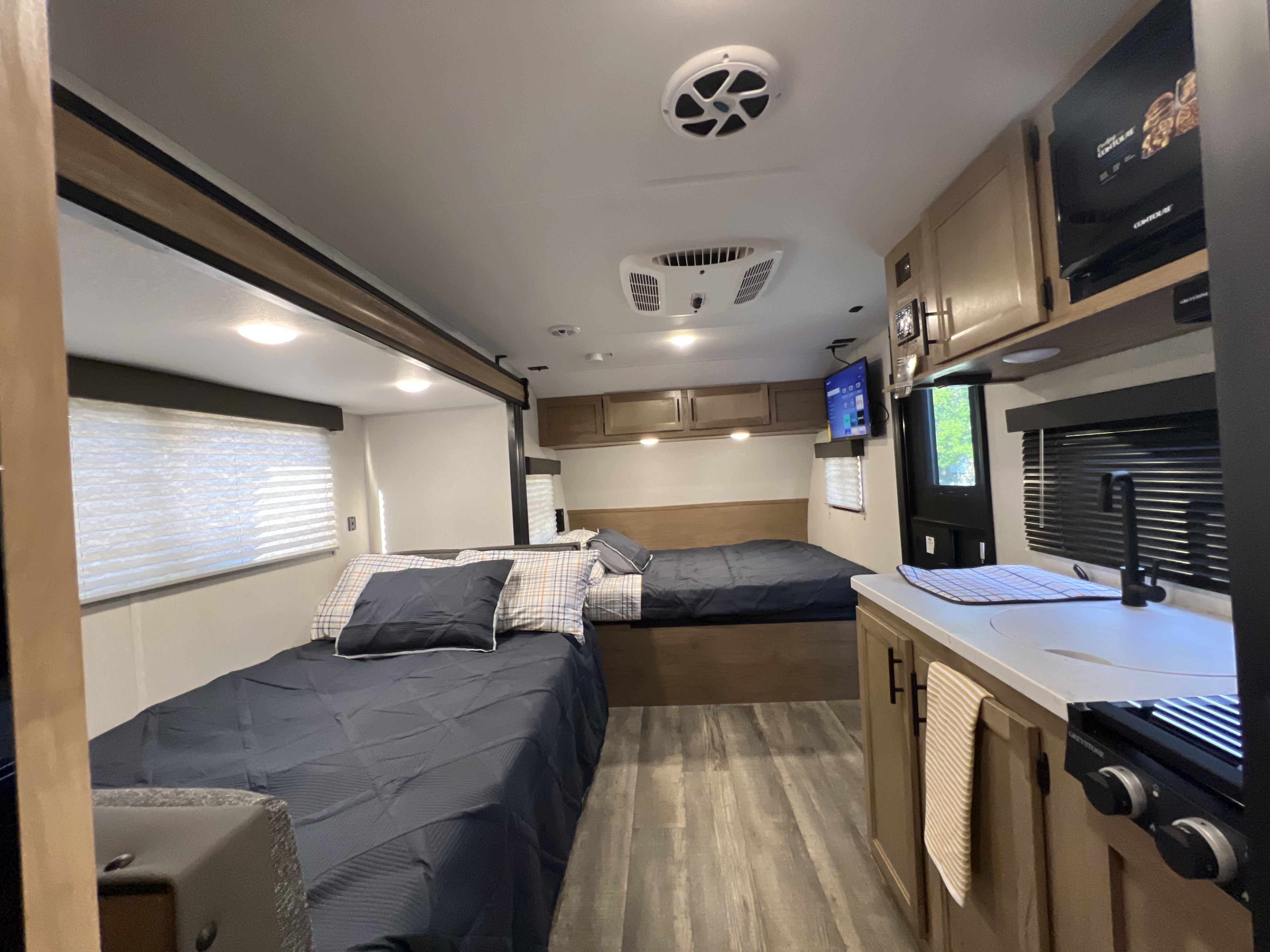 Spacious rv rental interior with cozy bunk beds, a fully equipped kitchen, and modern amenities for a comfortable road trip.. Forest River Cherokee Wolf Pup 2023