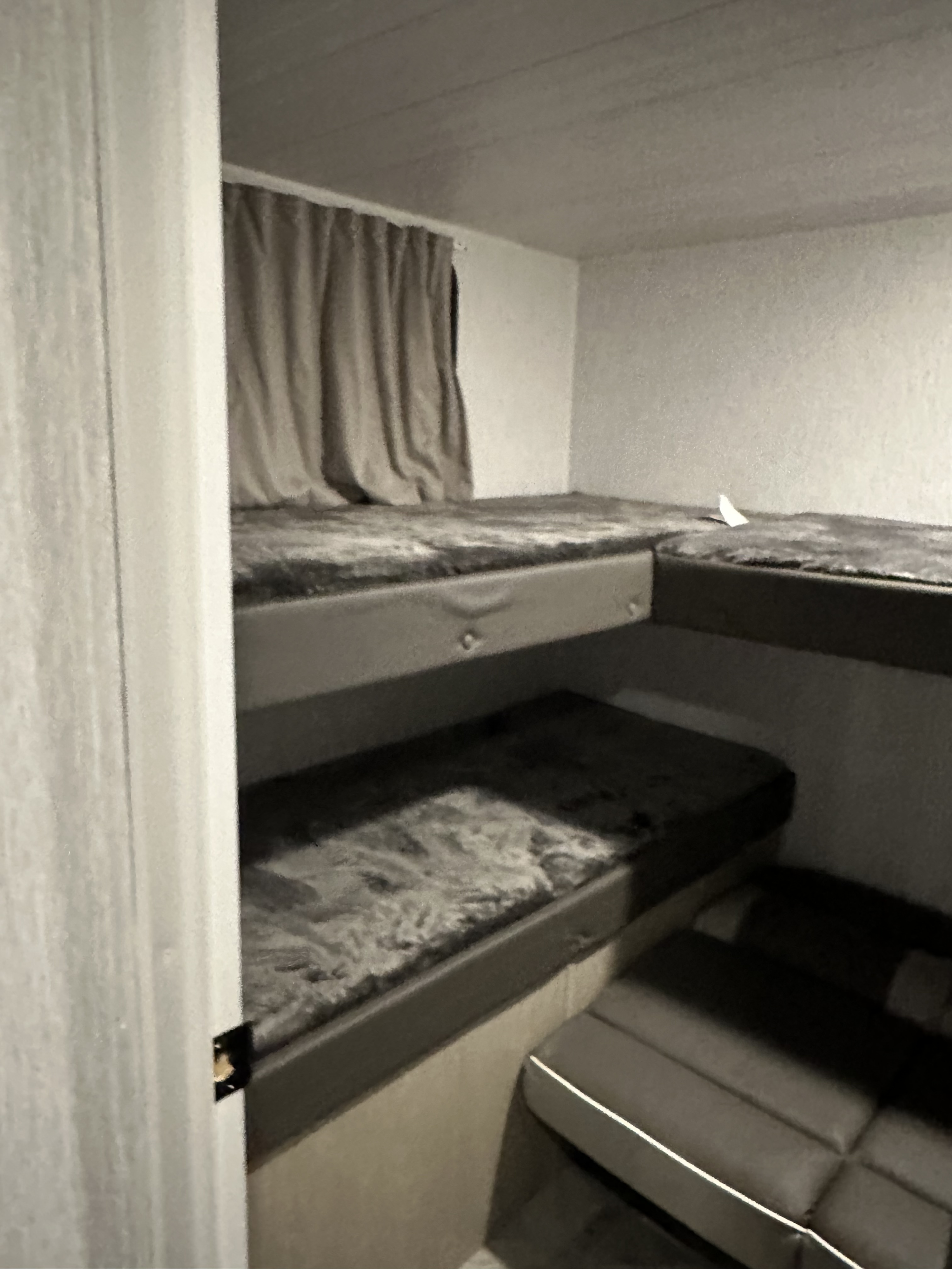 RV rental interior features bunk beds with curtains and a versatile seating area. Ideal for family adventures.. Forest River Wild wood 2024