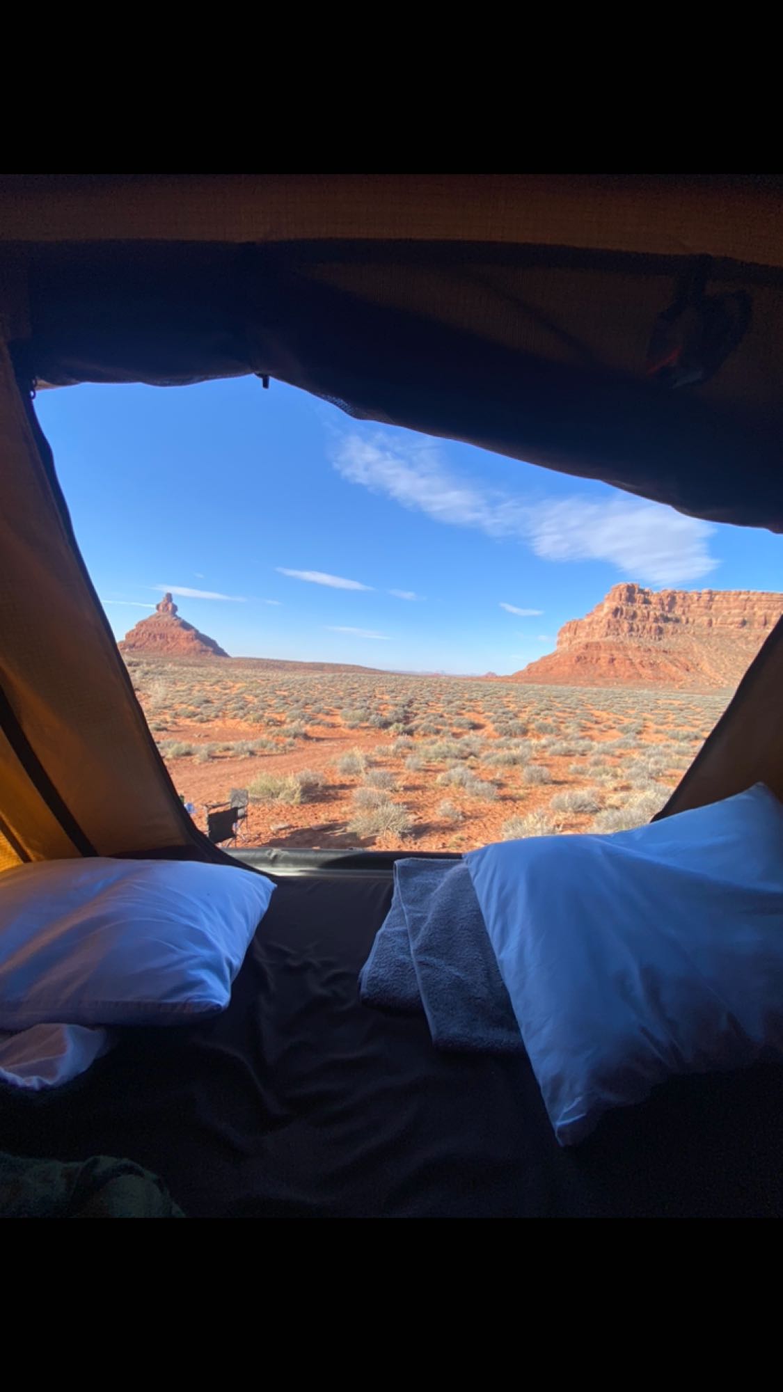 Desert morning from an RV rental: Red rocks & vast landscape seen through the tent opening. Bedding & pillows inside.. Toyota Other 2011
