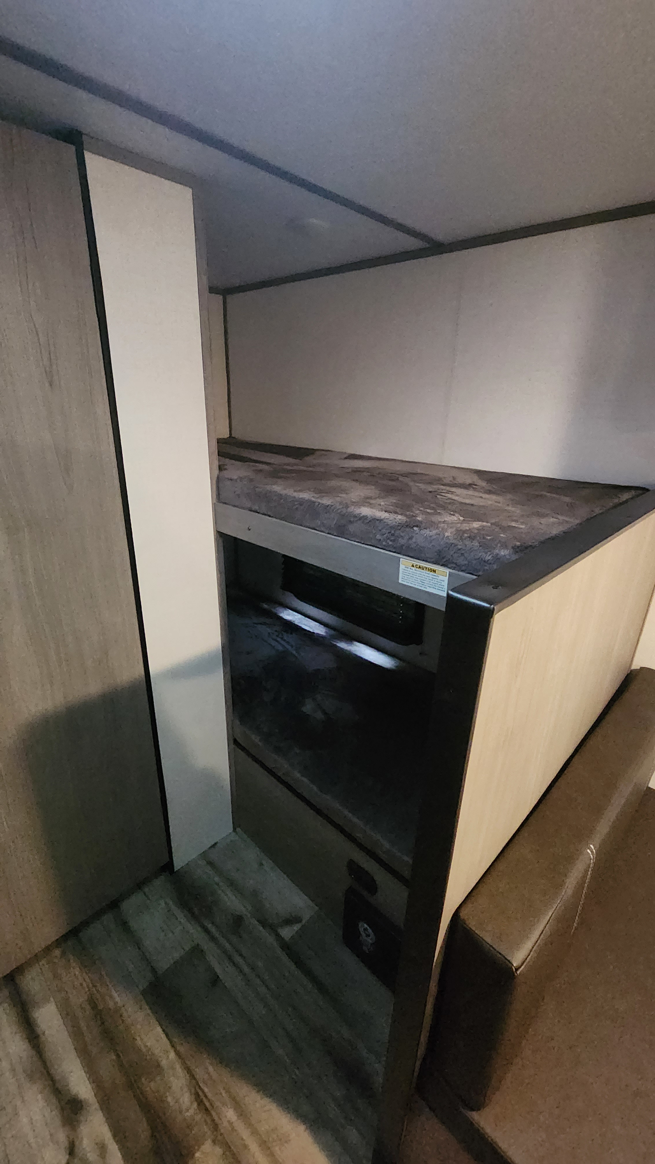 RV rental interior featuring a compact bunk bed setup with storage and a seating area, ideal for travel.. Keystone RV Lantern 17B 2024