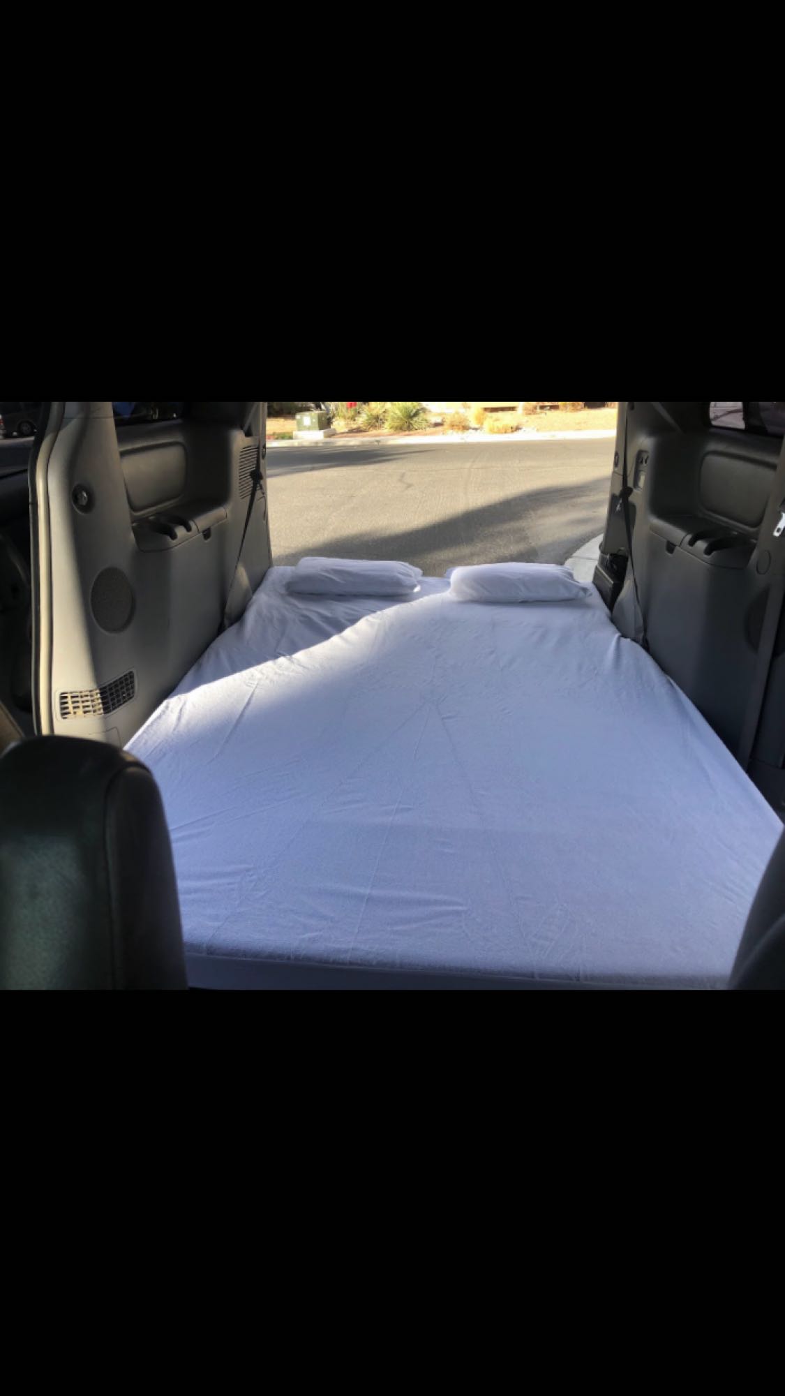 RV rental: Vehicle interior featuring a comfortable bed setup, ideal for car camping adventures.. Other Other 2009