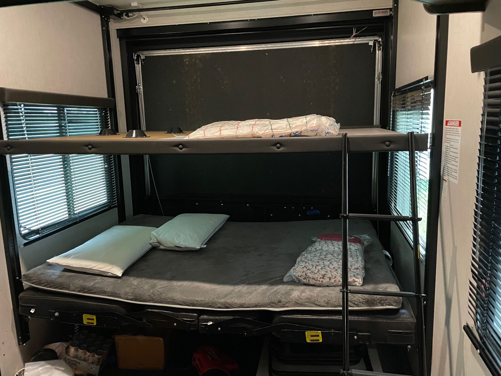 RV rental interior features bunk beds with mattresses, pillows, and a ladder, maximizing sleeping space.. Heartland Torque 2019
