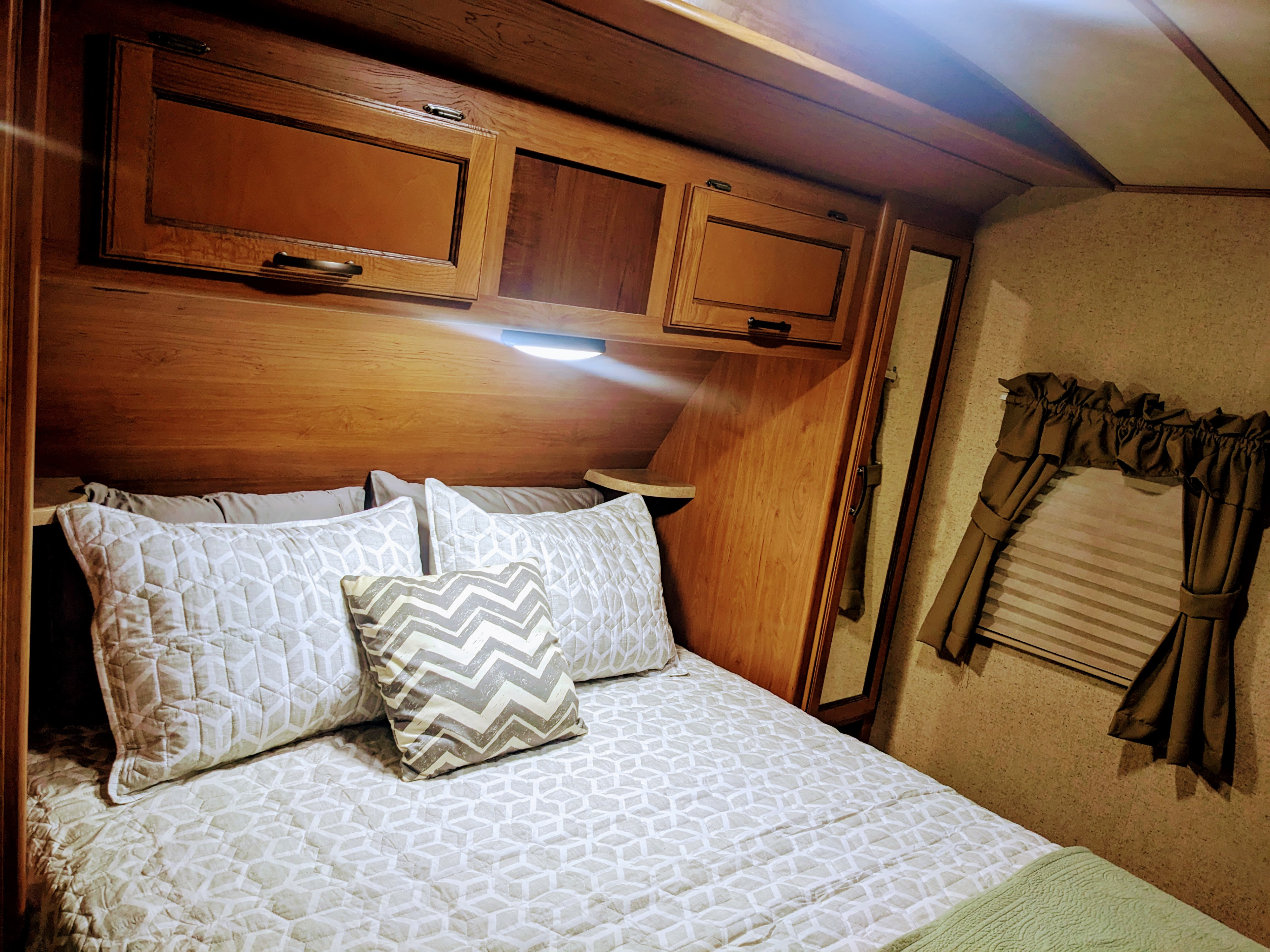 Front sleeping area with a REAL queen bed mattress.  Wardrobe storage on each side of the bed with additional storage above bed.. Crossroads RV Sunset Trail Super Lite 2017