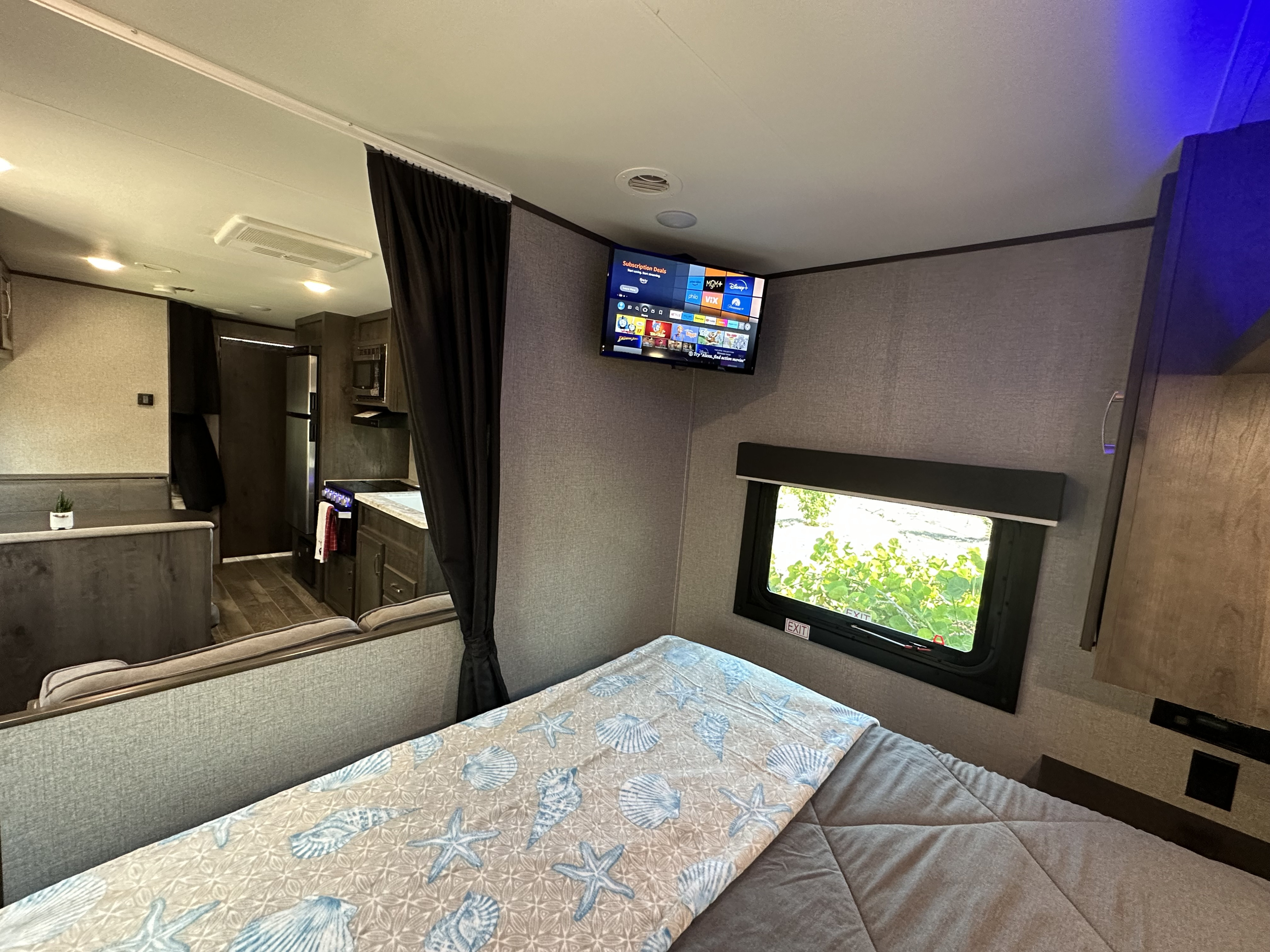 This RV rental offers a comfy bed, TV with streaming, window (with 'EXIT' label), kitchen & dining.. Jayco Jay Flight SLX 2020