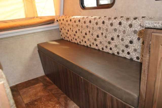 RV rental's inviting seating area: brown bench with patterned cushions and warm wood flooring.. Clipper Clipper Trailer 2016