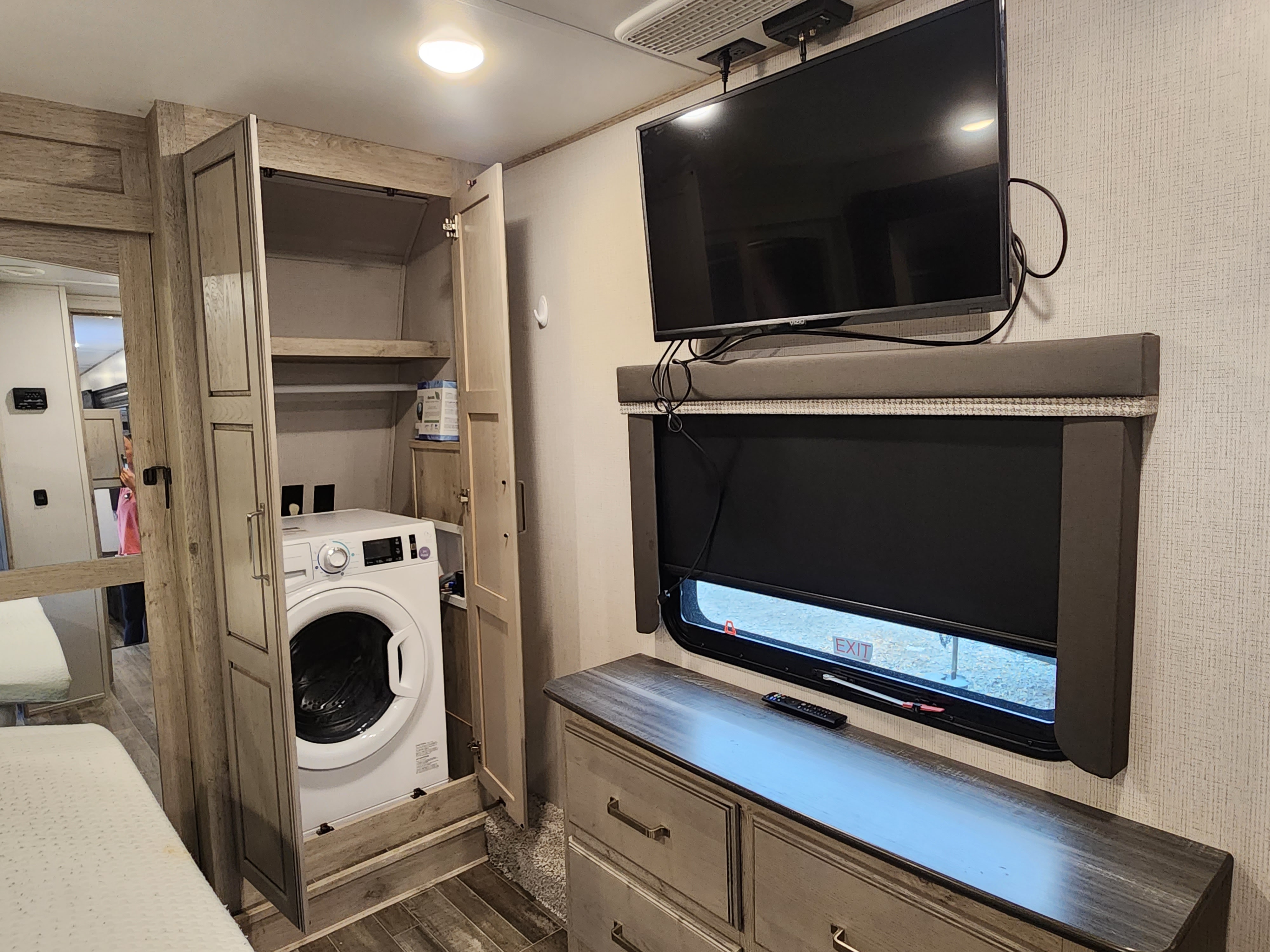 RV rental: Bedroom featuring a convenient washer/dryer combo, dresser, storage, and TV.. Keystone Avalanche 2021