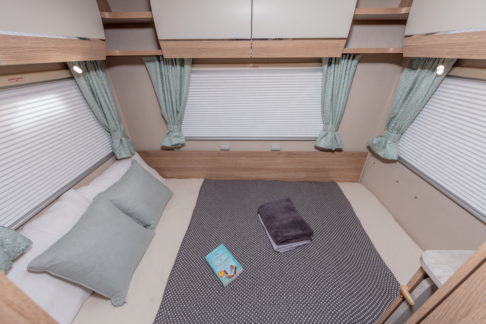 Cozy RV rental bedroom setup featuring a large bed, soft linens, blinds, and curtains. Ideal for relaxation.. Auto-Trail Imala 736 2024