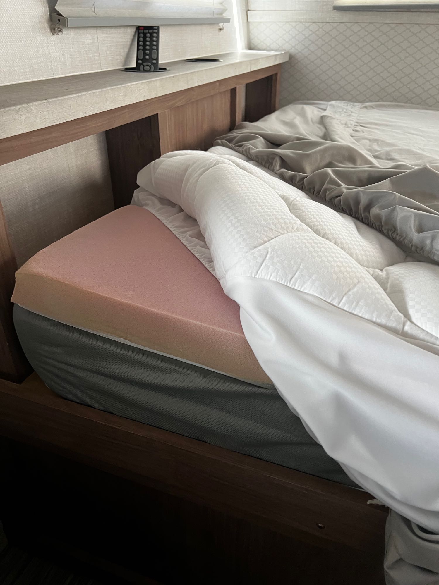 Get comfy in this RV rental! Features a plush bed with pink foam topper, quilted pad, and soft sheets. Remote by the bed.. No Boundaries 19 2020