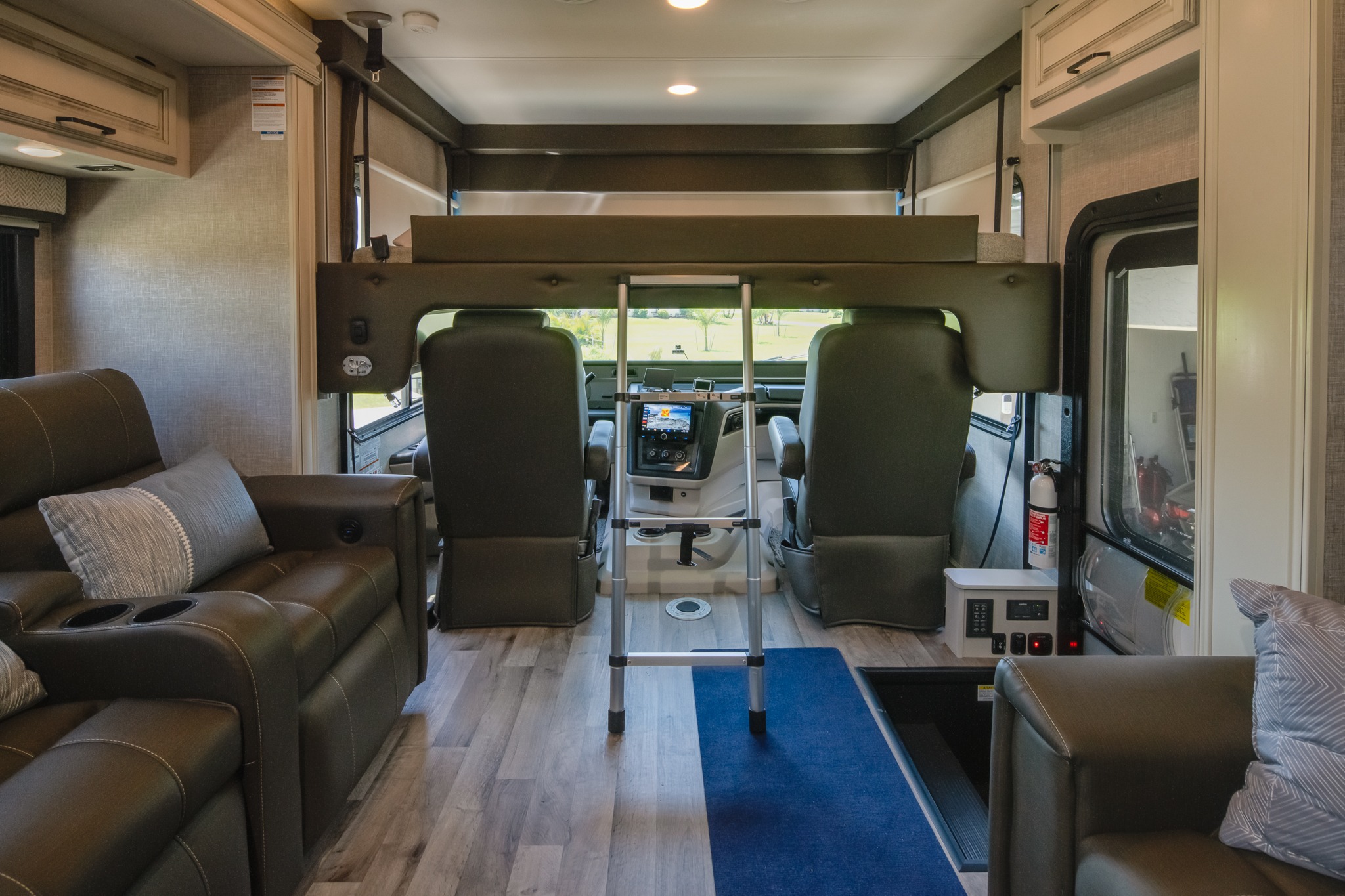 Spacious rv rental interior with cockpit, bunk bed, and recliners, offering comfort for travel adventures.. Jayco Precept 2023