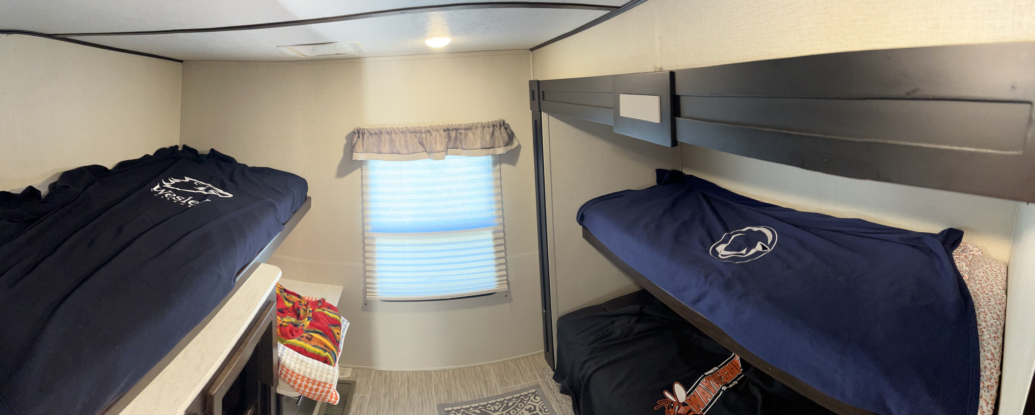 Compact RV rental bunk bed area with window and four sleeping spots, ideal for families on the go.. Forest River Lacrosse Luxury Lite 2018