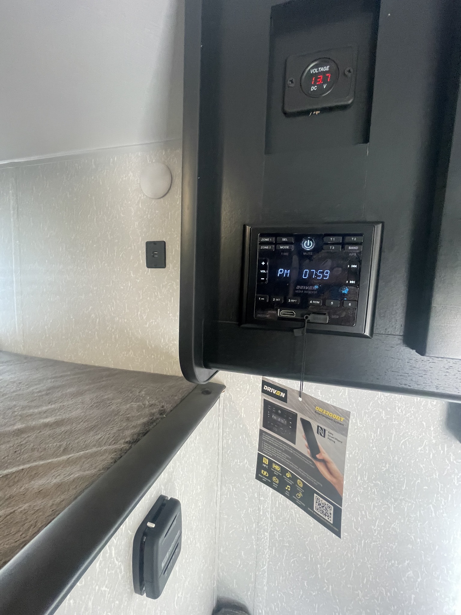 RV rental bunk area: DRIVEN entertainment system (07:59), 13.7V power meter, and USB port visible.. Forest River Cherokee Wolf Pup 2022