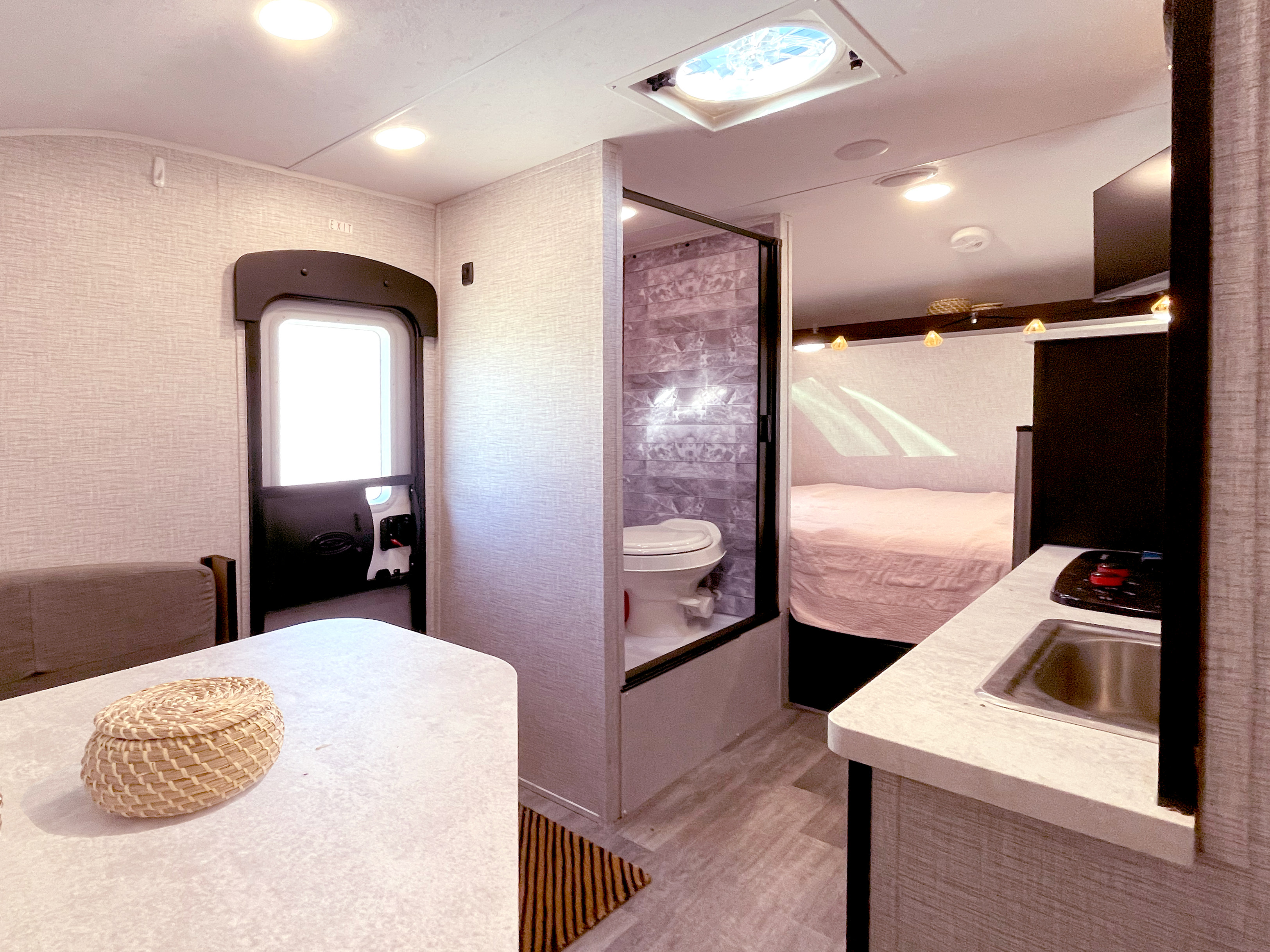 Cozy RV rental interior showcasing dinette, bathroom, kitchen, and bed areas for comfortable travel.. Braxton Creek Bushwhacker Plus 2022