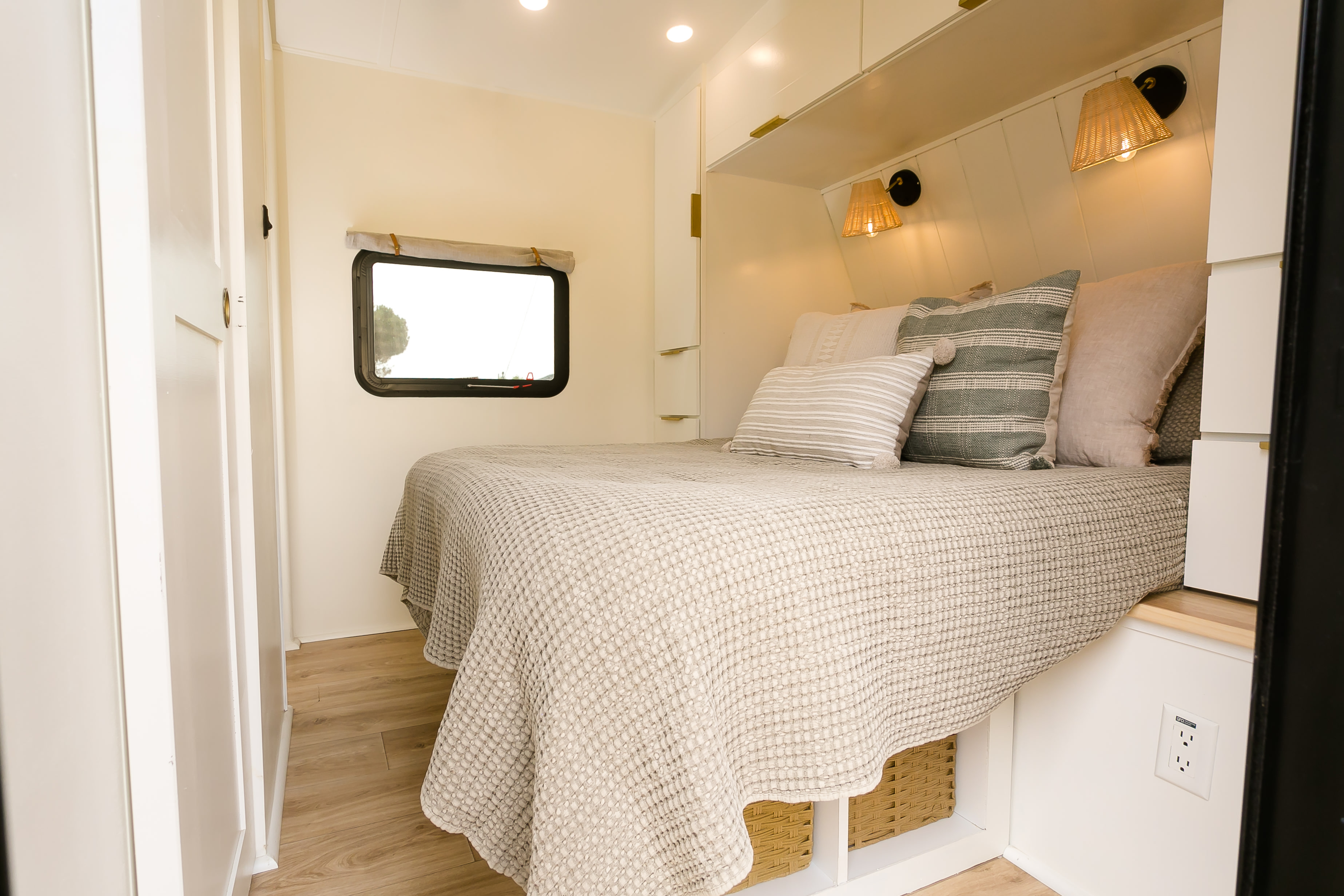 Experience comfort in this cozy RV rental bedroom with a textured bedspread, soft pillows, and ambient lighting.. Grand Design Imagine 3250BH 2021