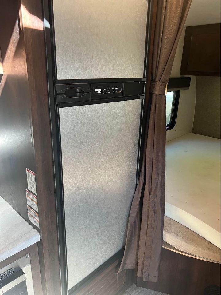 RV rental: View inside shows a tall, stainless-look refrigerator and a bed area, offering comfort for your journey.. Jayco Octane 2018