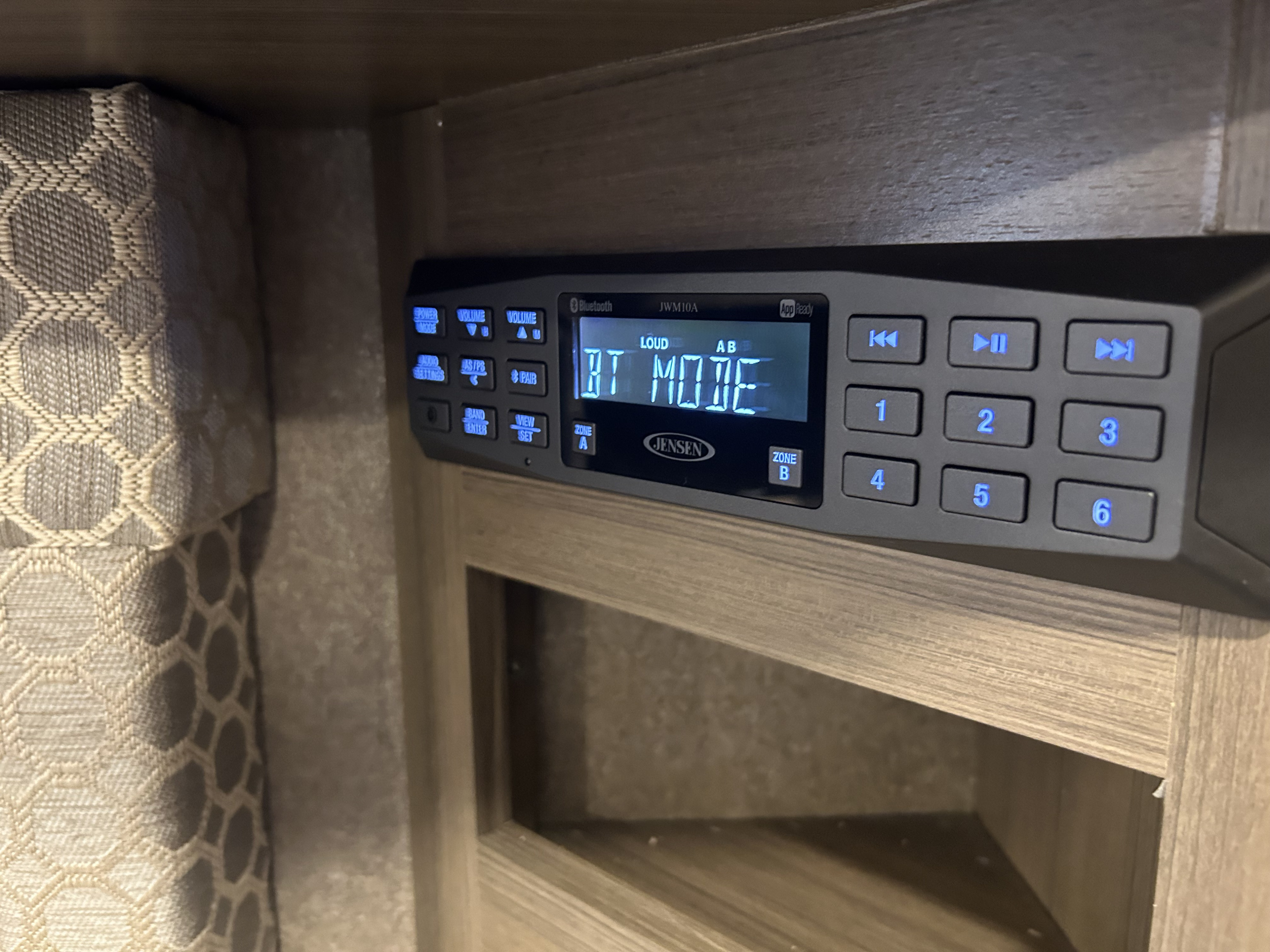 RV rental interior: Jensen JWM10A stereo showing "BT MODE," ready for your mobile entertainment.. Thor Axis 2018