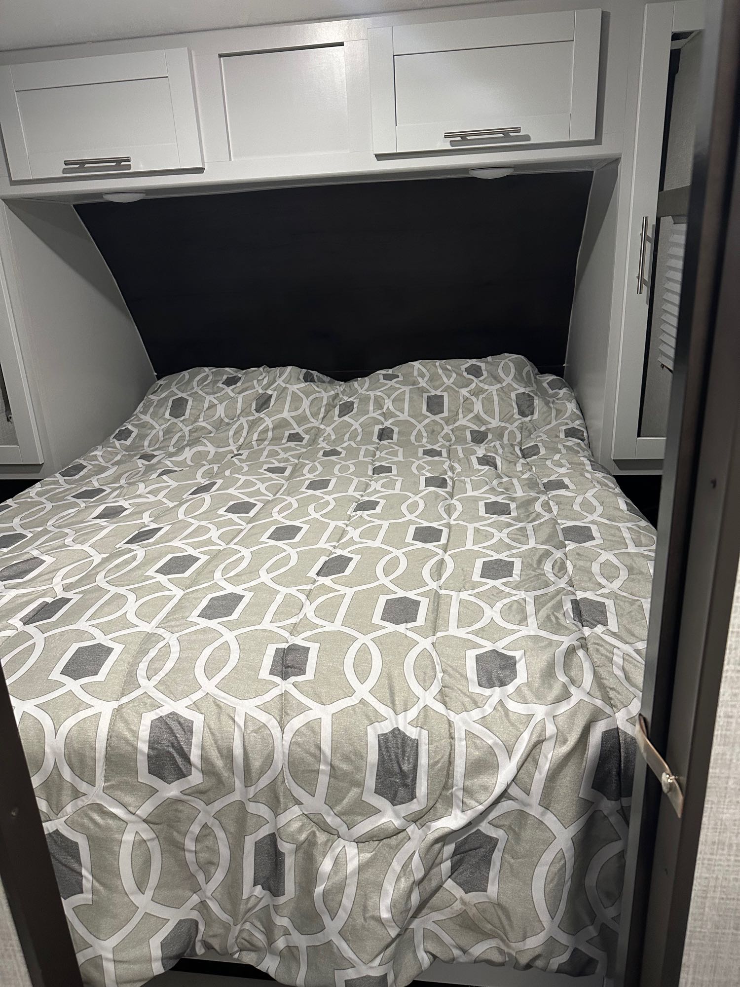 Master bedroom has private doors, queen size bed, storage above and closet space on the sides. Access to bathroom. . Keystone RV Bullet Ultra Lite 2020