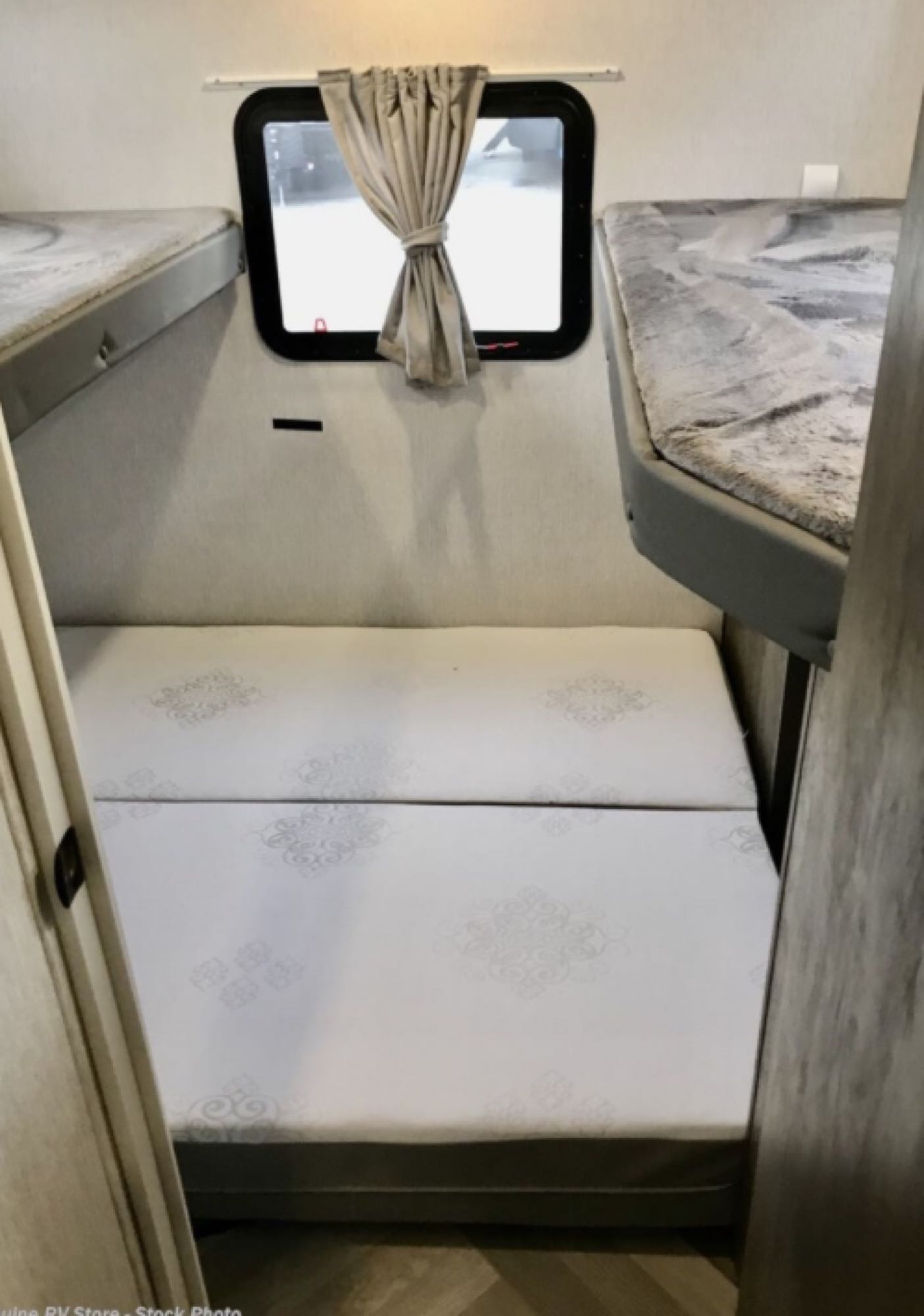 RV rental: Interior shows sleeping area with two upper bunk beds, lower mattresses, and window with curtain for comfort.. Forest River Salem Cruise Lite 2021