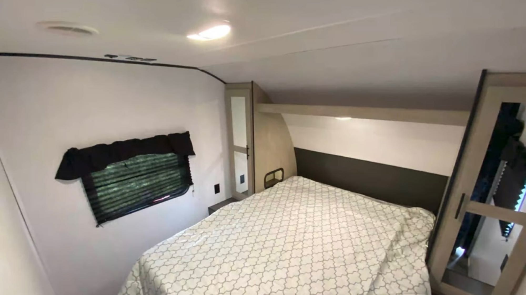 RV rental: A compact bedroom with a bed, window, and integrated storage. Ideal for comfortable travel.. Heartland RVs Prowler 2022