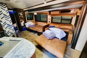 Spacious RV rental interior with comfortable living space, featuring a large sofa bed and pull-out for travel accommodation.. Jayco Jay Flight 2021