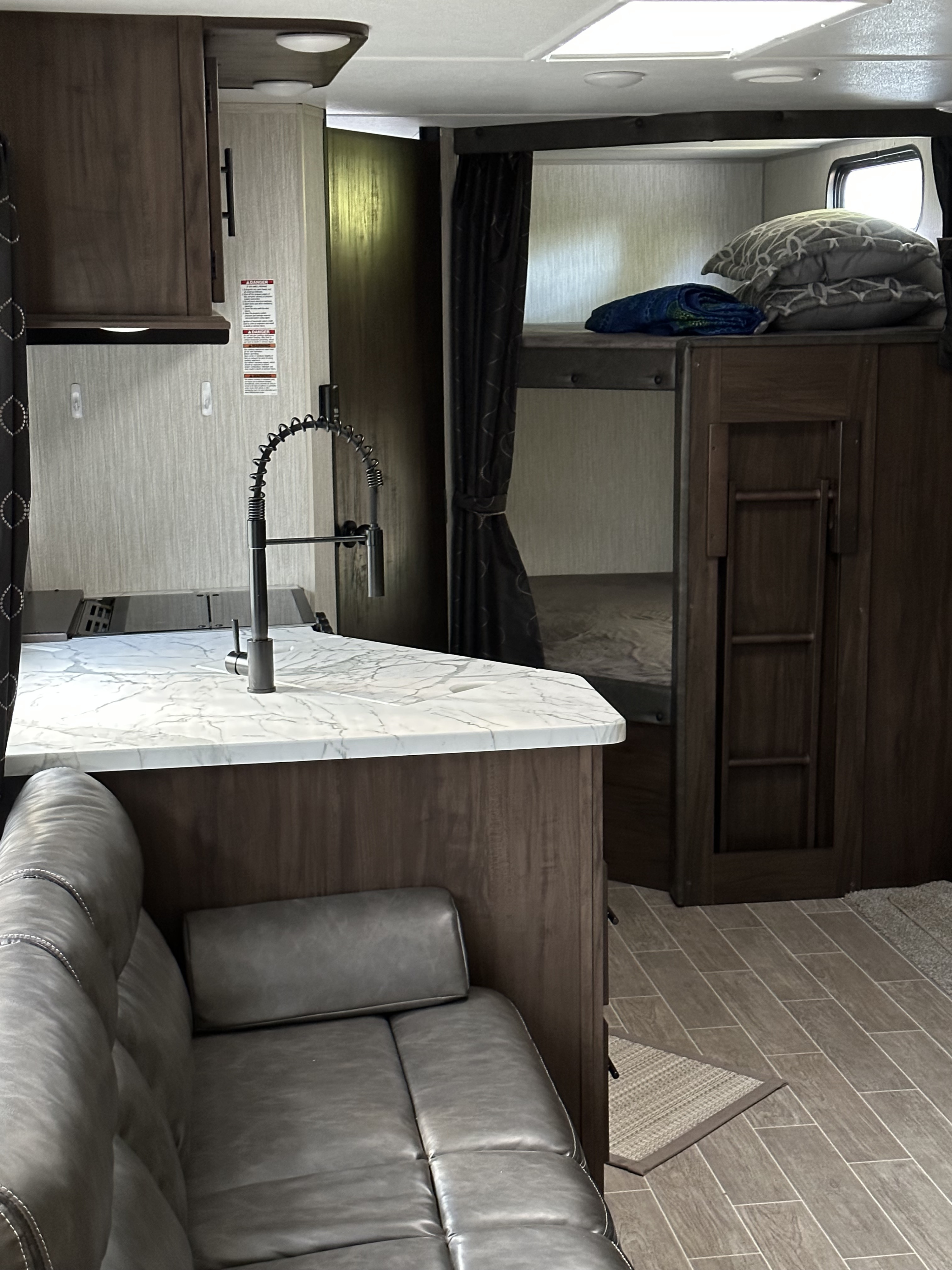 Kitchen pantry and bunks. Entrance to the bathroom . Forest River Cherokee 2021