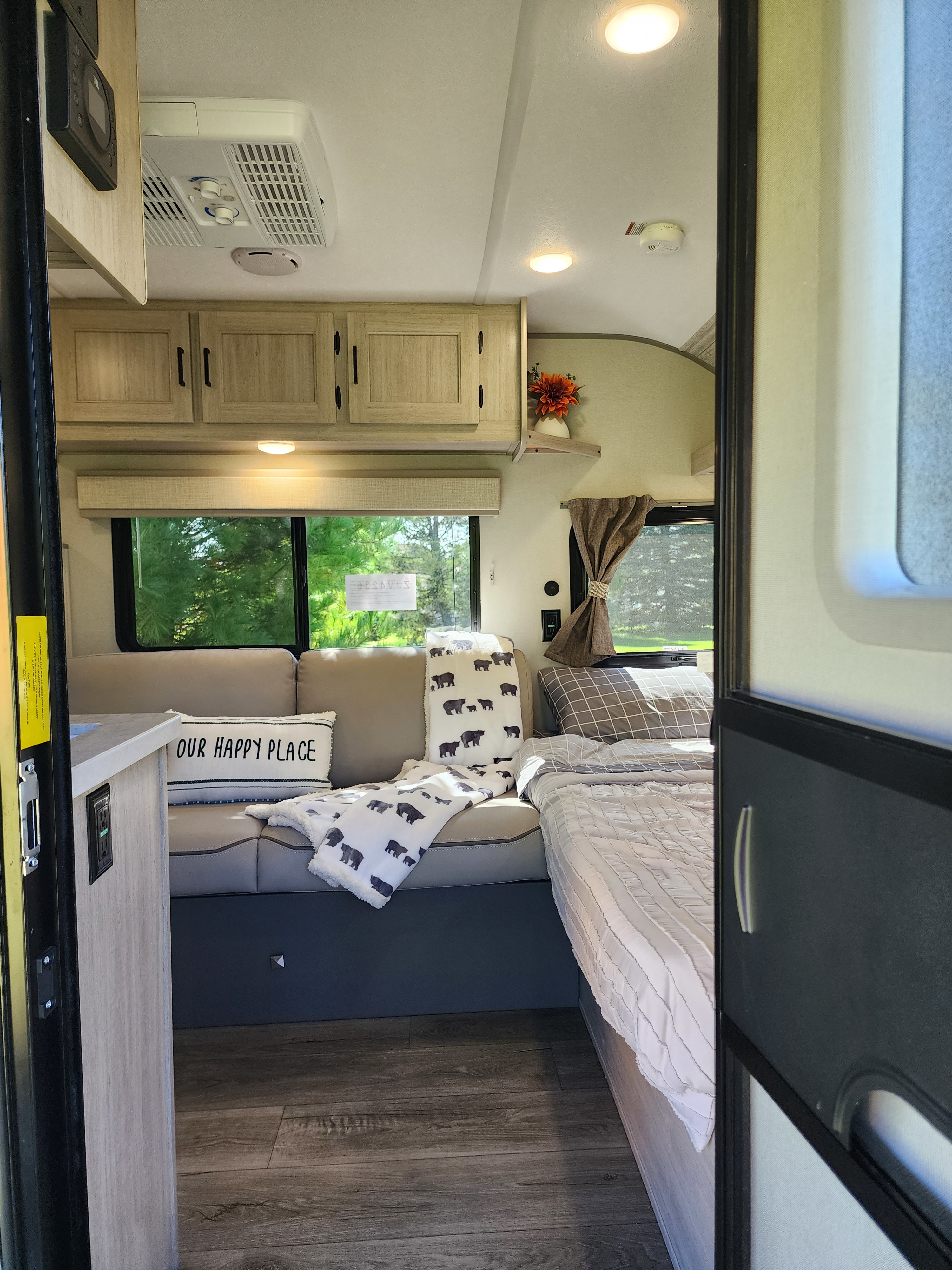Step inside this inviting rv rental, showcasing a bed, sofa, and windows with scenic views. Your happy place awaits!. Coachman Catalina Summit Series 7 2024