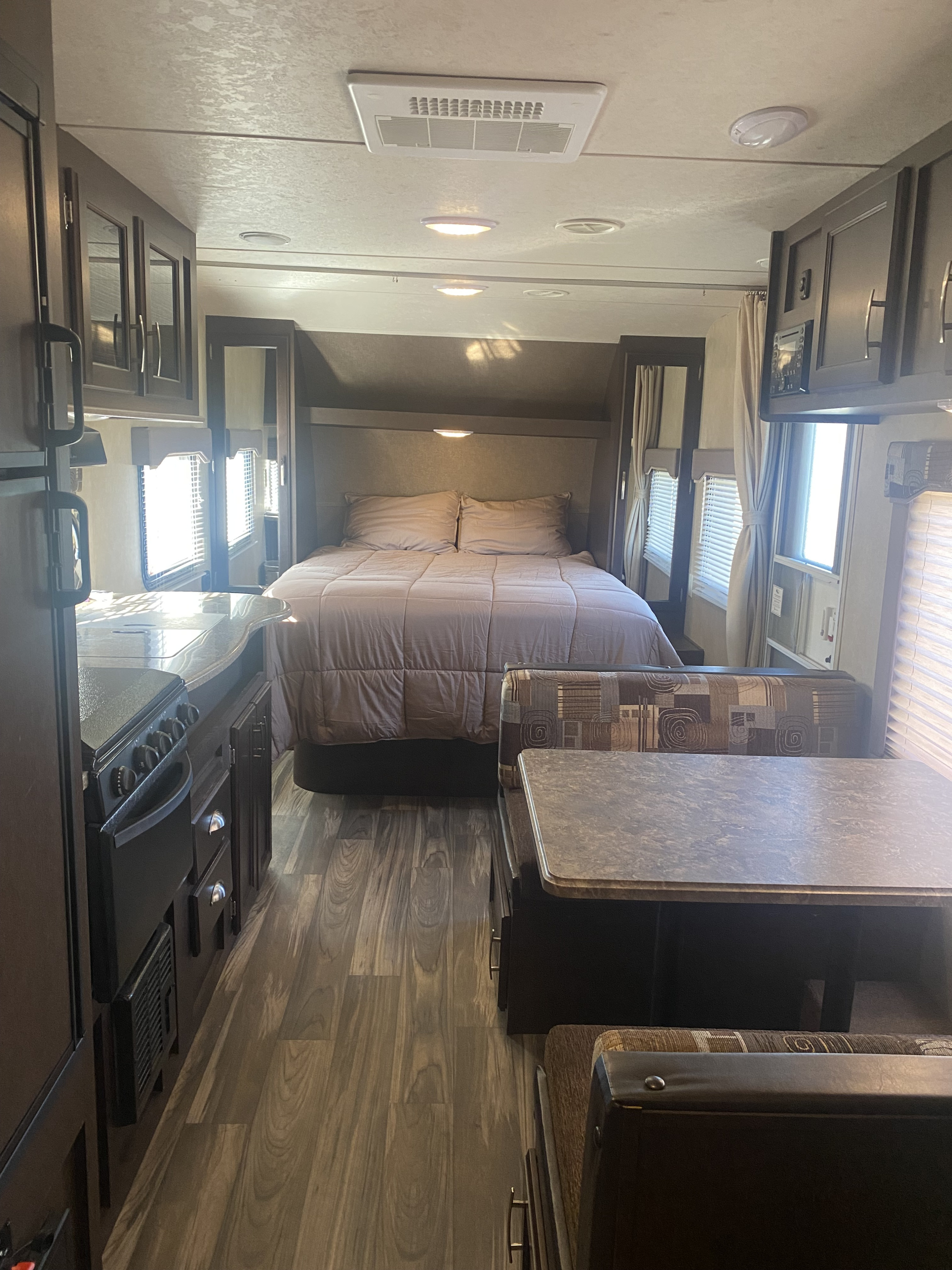 Spacious RV rental interior: bedroom, kitchen, and dinette visible. Your cozy home away from home.. Forest River Evo 2017