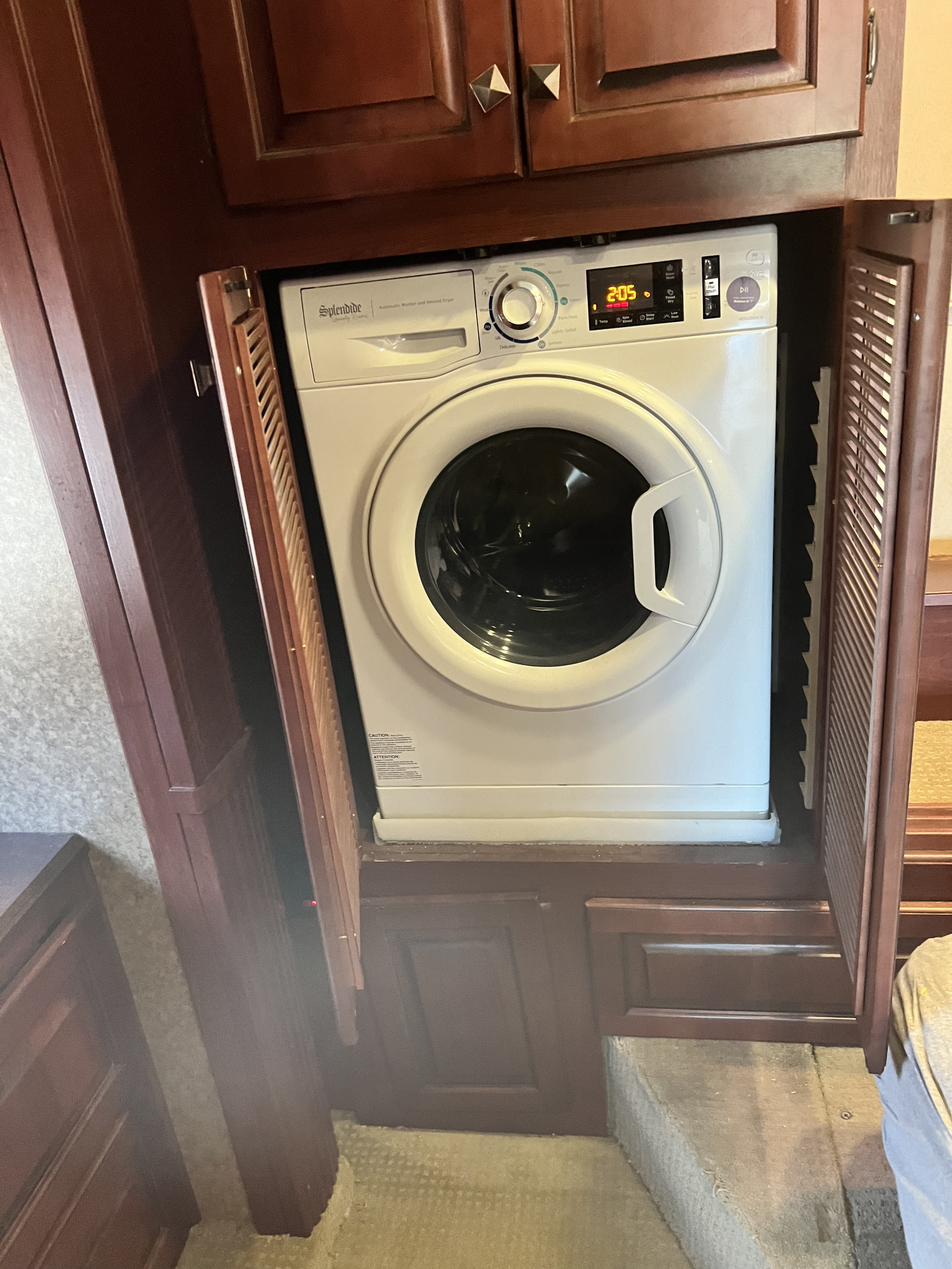 Compact Splendide RV washer/dryer combo, displaying '2:05', ideal for convenient laundry in an RV rental.. Berkshire Berkshire Motorhome 2013