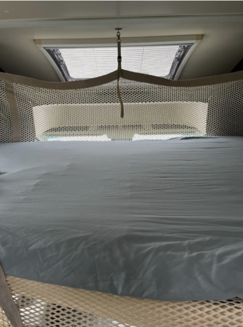Cozy RV rental bunk bed with safety net and skylight for comfortable travel.. Ford Rollerteam 696 2019