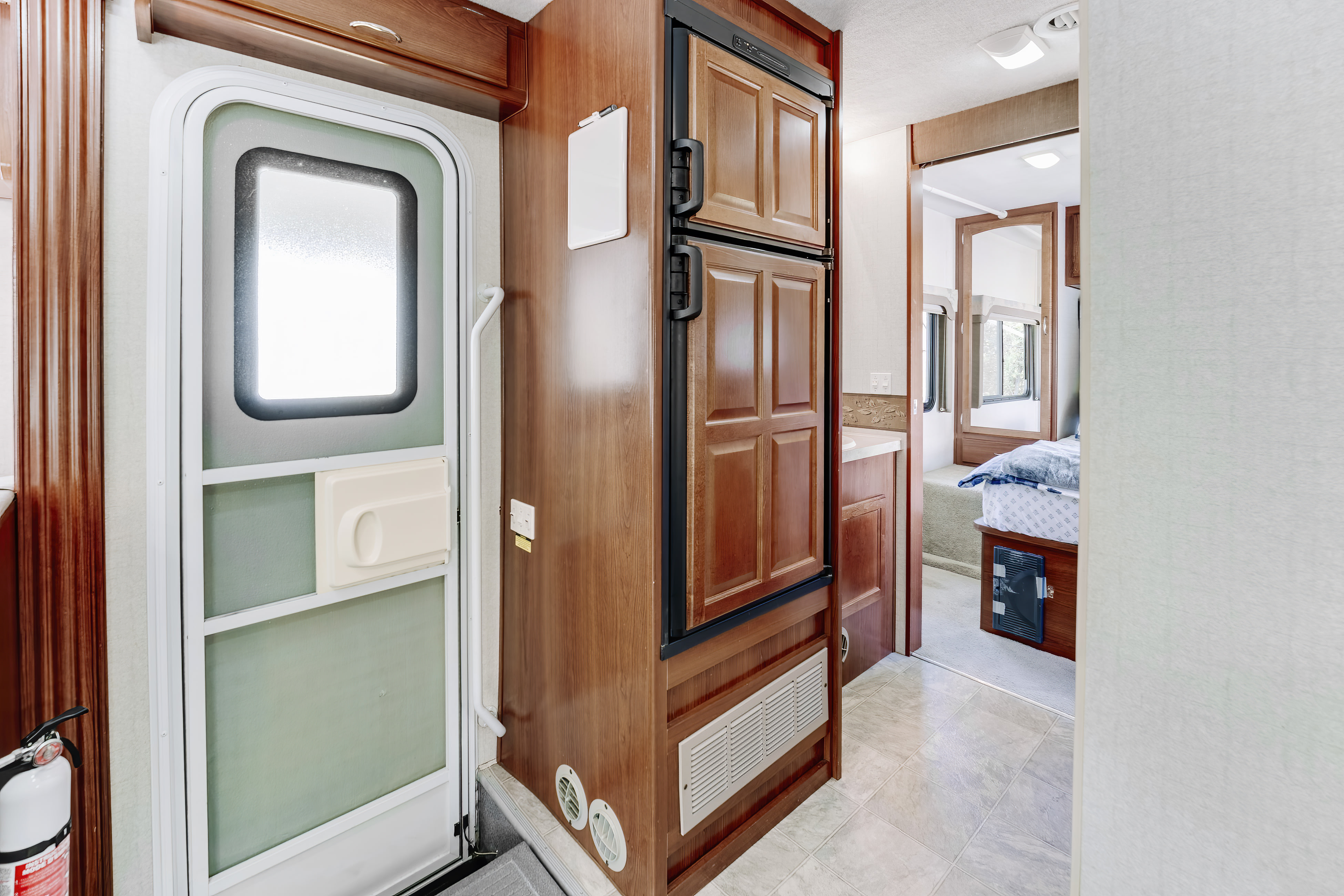Step inside this RV rental: front entry, integrated fridge, and a clear path to the rear bedroom area.. Tioga Tioga Motorhome 2008