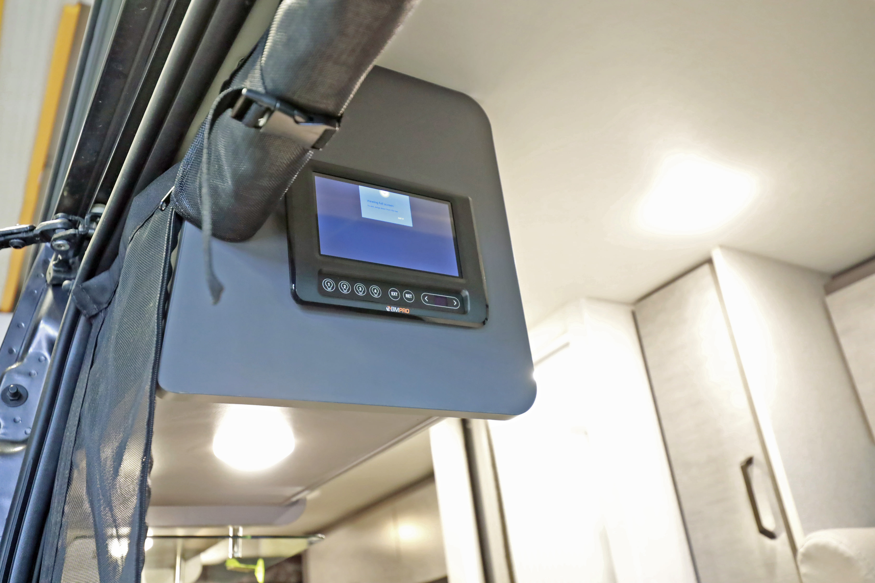 Inside a modern RV rental: a BMPRO smart control panel manages interior lighting and features, enhancing your travel experience.. Thor Motor Coach twist 2022