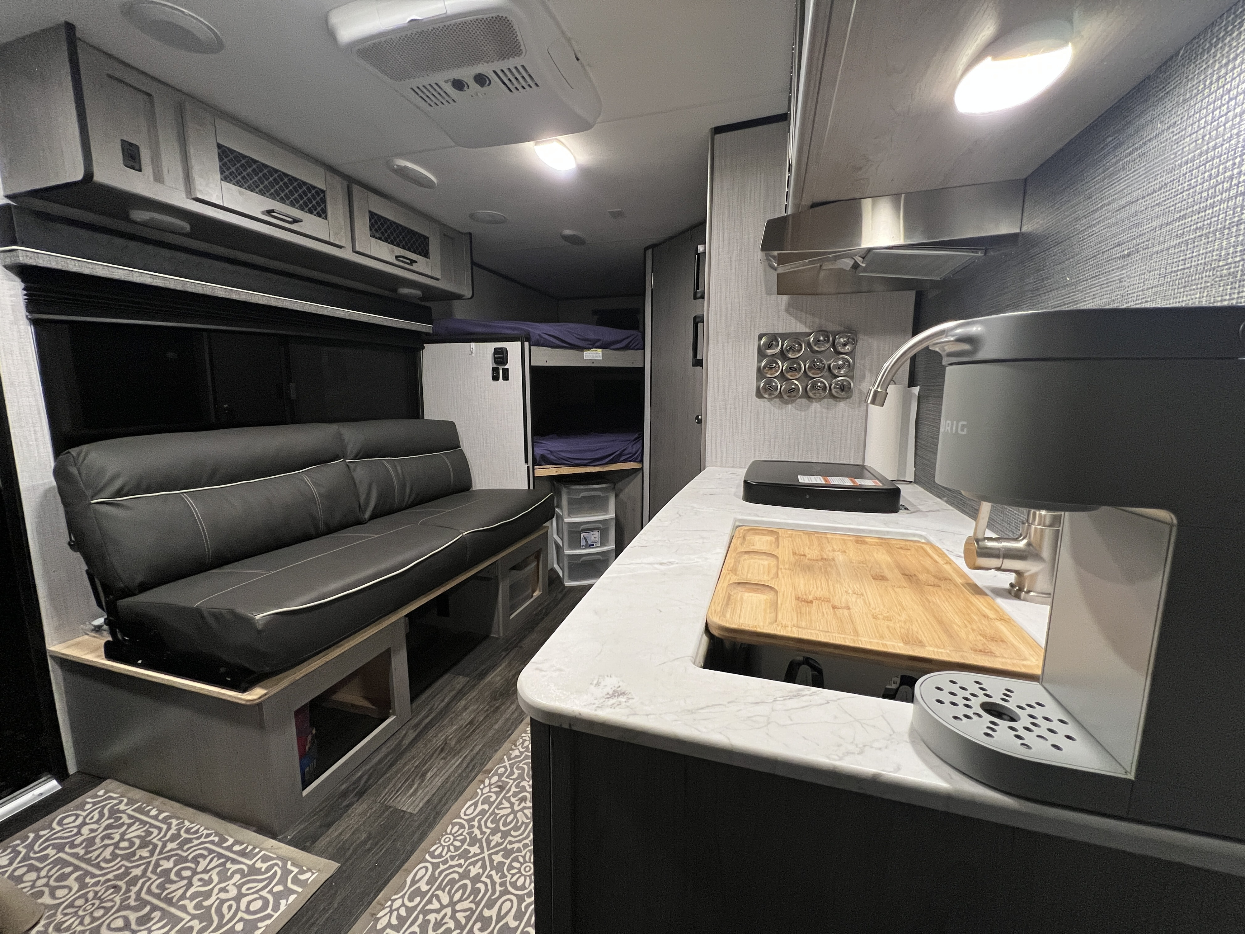 Clean & modern RV rental interior featuring a full kitchen, comfy seating area, and bunk beds.. Heartland RVs Mallard 2021