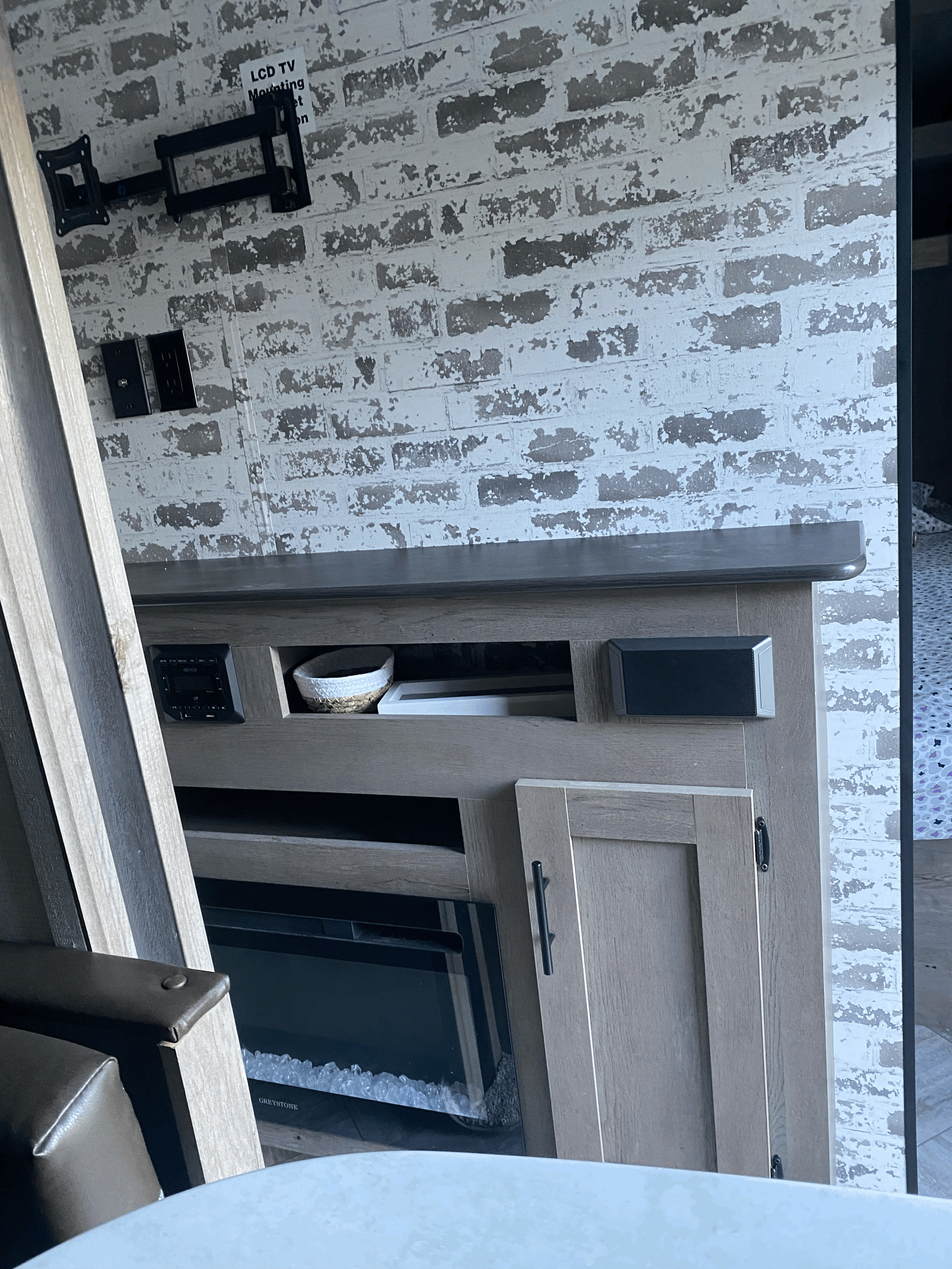 RV rental: Entertainment center with electric fireplace, TV mount, and a faux brick accent wall.. Keystone RV Springdale 2021